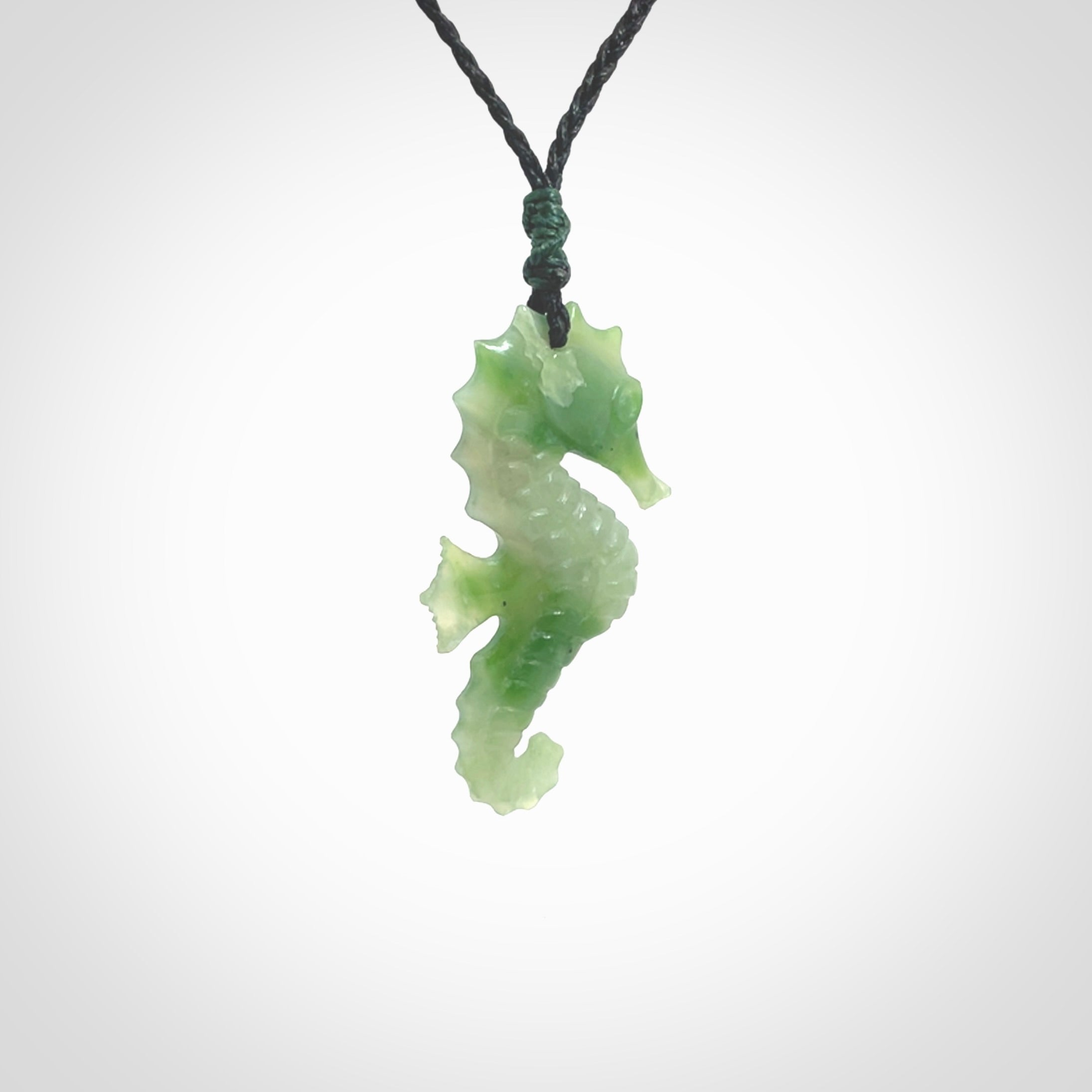 A hand carved seahorse pendant. We have carved this from beautiful nephrite jade and we bind them with our hand-plaited cords. the cords are a waxed polyester so they are durable and strong. We ship these worldwide with express courier anywhere in the world.