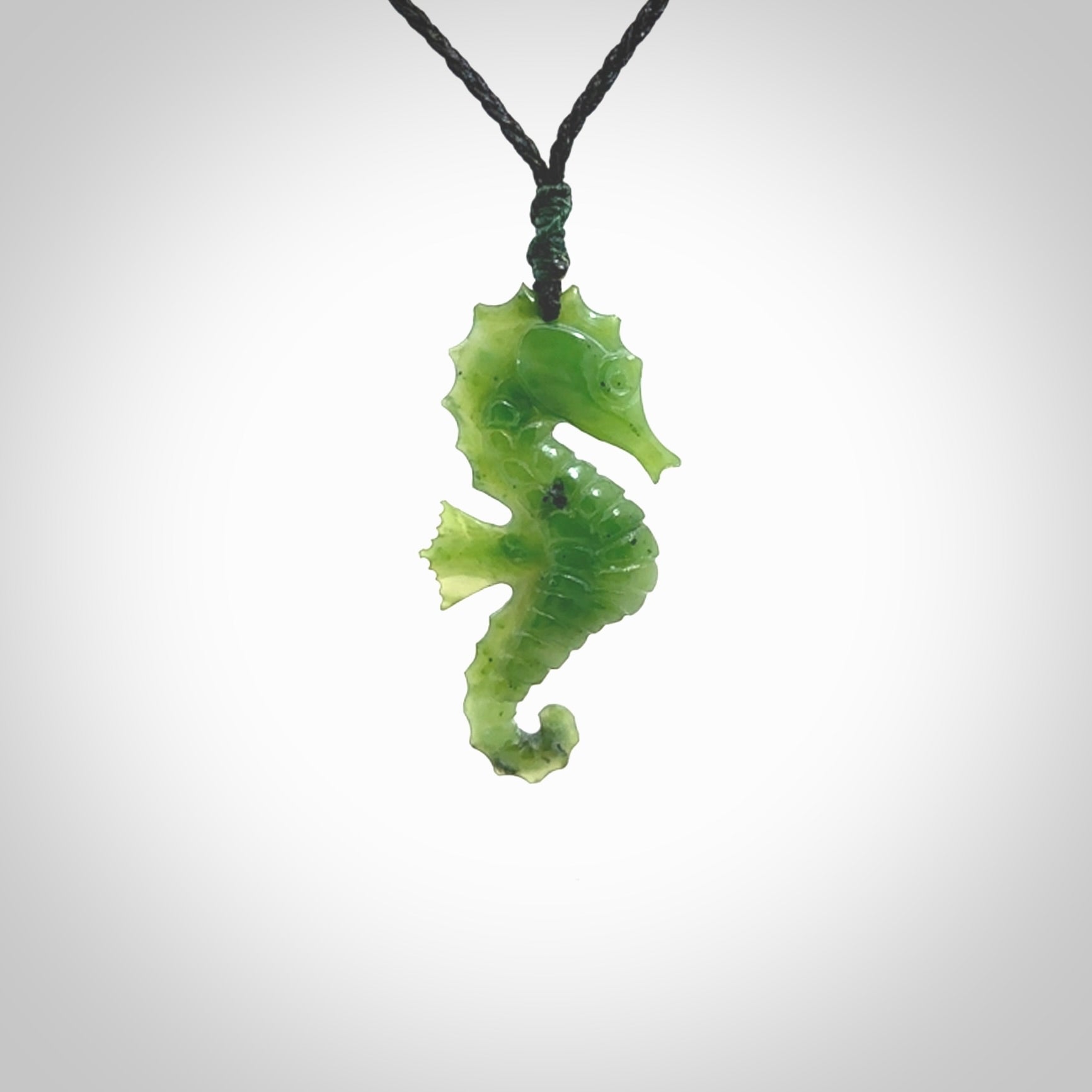 A hand carved seahorse pendant. We have carved this from beautiful nephrite jade and we bind them with our hand-plaited cords. the cords are a waxed polyester so they are durable and strong. We ship these worldwide with express courier anywhere in the world.