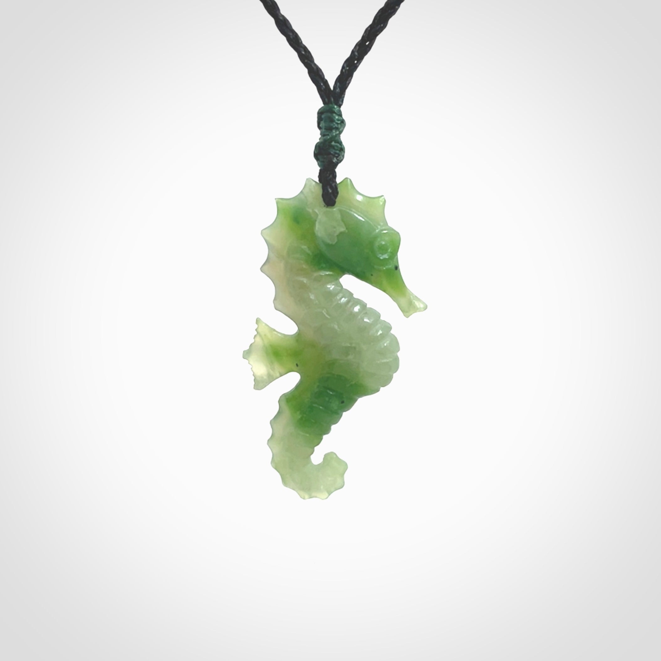 A hand carved seahorse pendant. We have carved this from beautiful nephrite jade and we bind them with our hand-plaited cords. the cords are a waxed polyester so they are durable and strong. We ship these worldwide with express courier anywhere in the world.