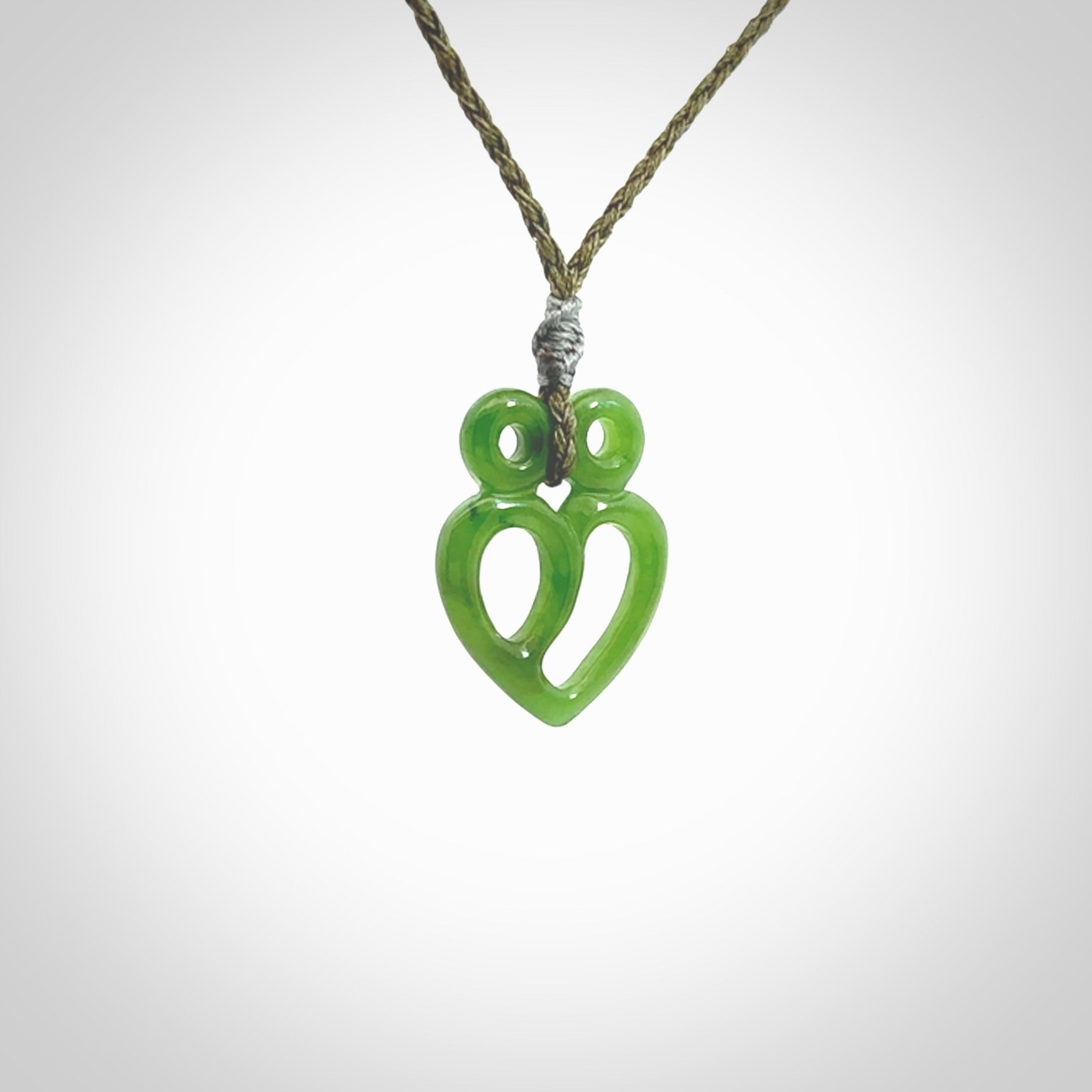 This is a handcarved love heart pendant made from a gorgeous and striking piece of British Columbia Jade stone. This is a superbly carved and very unique piece if custom jewellery. For sale online from NZ Pacific.