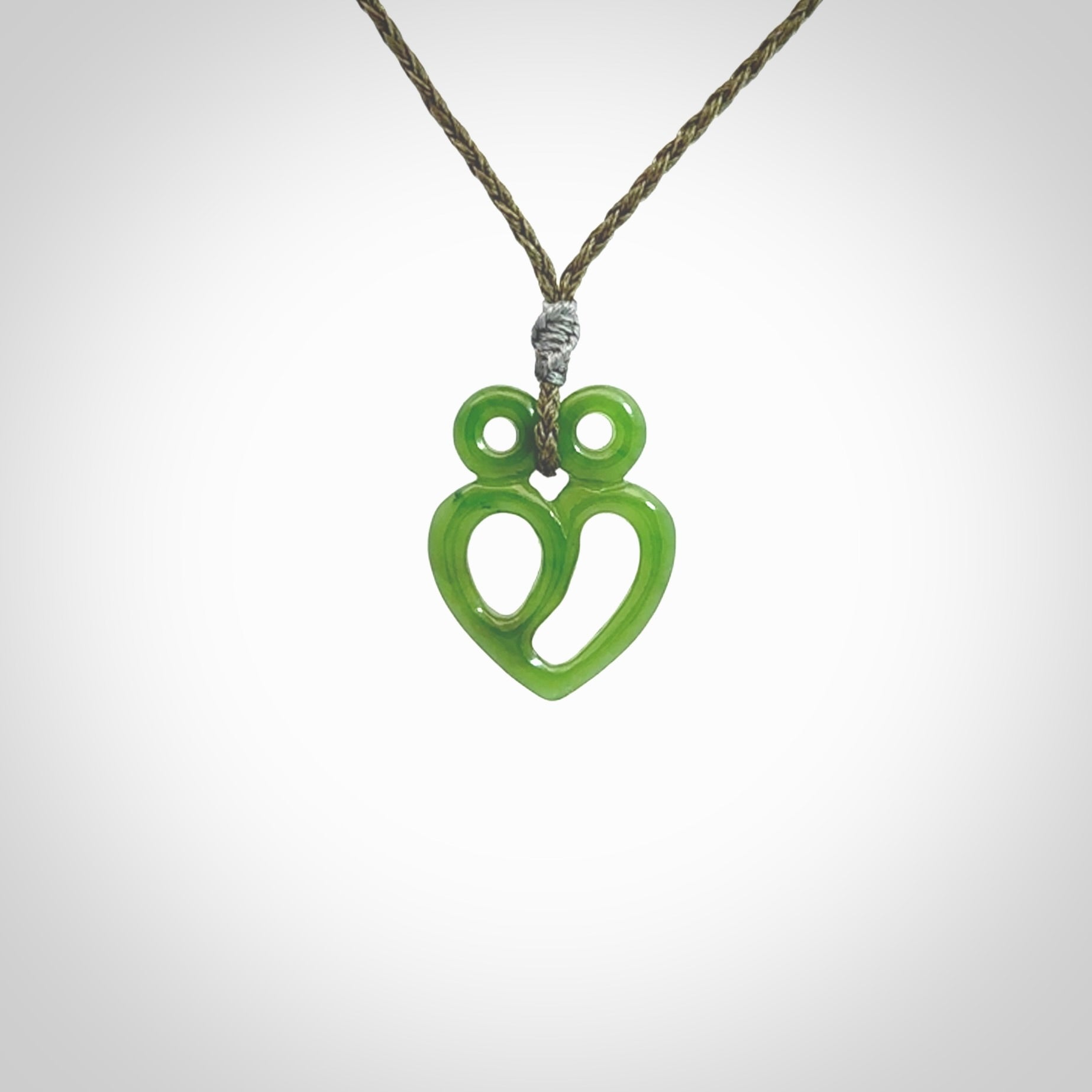 This is a handcarved love heart pendant made from a gorgeous and striking piece of British Columbia Jade stone. This is a superbly carved and very unique piece if custom jewellery. For sale online from NZ Pacific.