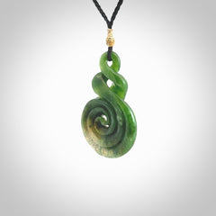 Ross Crump double twist with koru pendant. Hand carved from rare New Zealand Flower jade this is a beautiful pounamu pendant. The cord is length adjustable. It is a delicate and very beautiful greenstone pendant. For sale online by NZ Pacific.