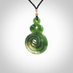 Ross Crump double twist with koru pendant. Hand carved from rare New Zealand Flower jade this is a beautiful pounamu pendant. The cord is length adjustable. It is a delicate and very beautiful greenstone pendant. For sale online by NZ Pacific.