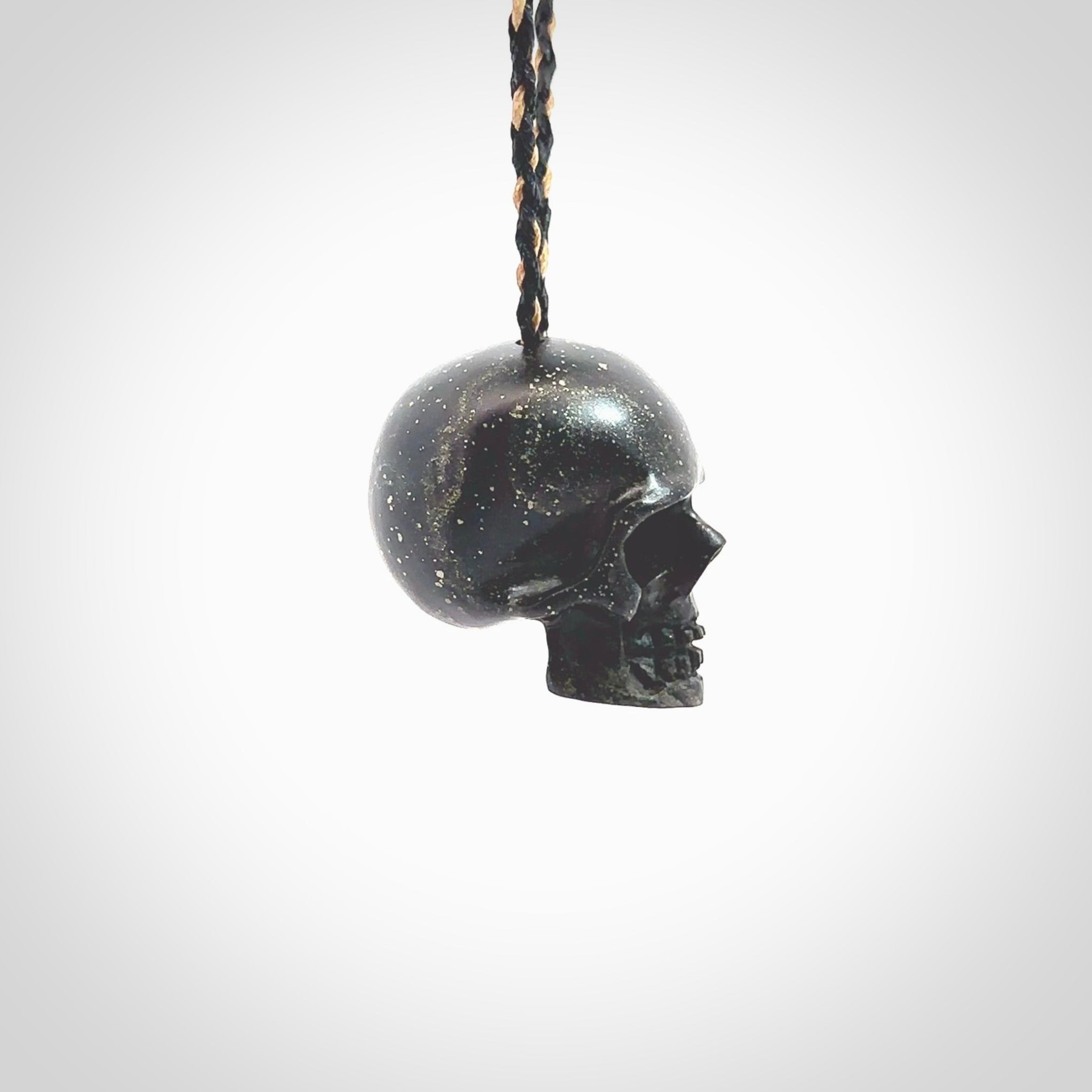 This picture shows a large sized Snowflake Obsidian stone skull pendant that we have hand carved. It is polished to a soft shine and is a very striking piece. Provided with an adjustable black and tan cord.