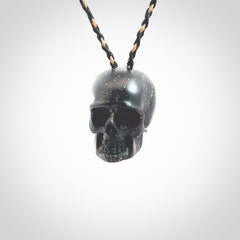 This picture shows a large sized Snowflake Obsidian stone skull pendant that we have hand carved. It is polished to a soft shine and is a very striking piece. Provided with an adjustable black and tan cord.