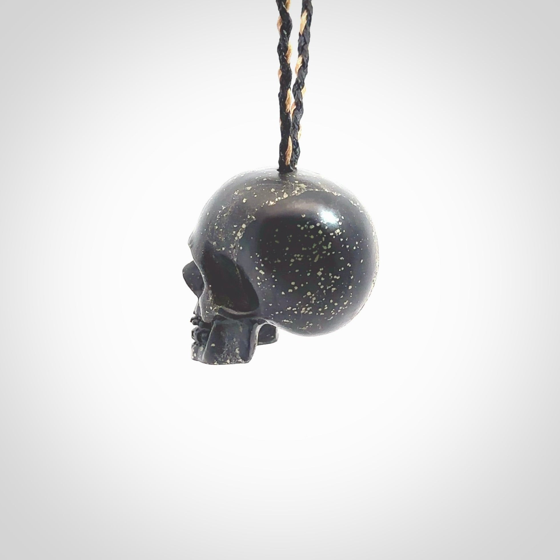 This picture shows a large sized Snowflake Obsidian stone skull pendant that we have hand carved. It is polished to a soft shine and is a very striking piece. Provided with an adjustable black and tan cord.