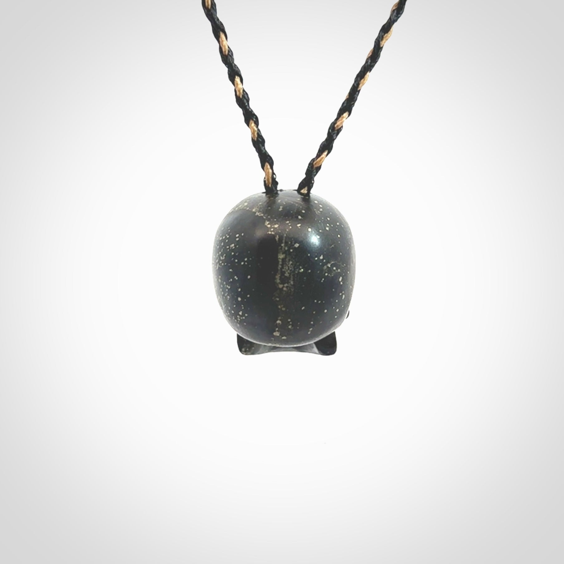 This picture shows a large sized Snowflake Obsidian stone skull pendant that we have hand carved. It is polished to a soft shine and is a very striking piece. Provided with an adjustable black and tan cord.