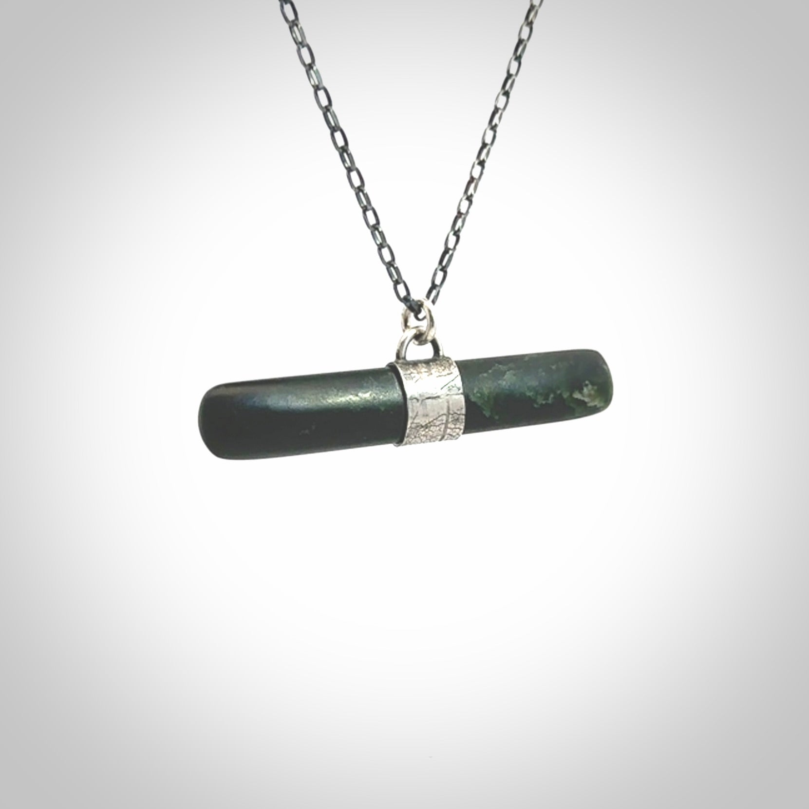 This is a beautiful green fob style drop design pendant that we has been carved here in New Zealand by Josey Coyle. It is carved from a piece of New Zealand Marsden Jade pounamu with Sterling Silver fittings and a sterling silver chain. A contemporary drop shaped pendant made to wear.