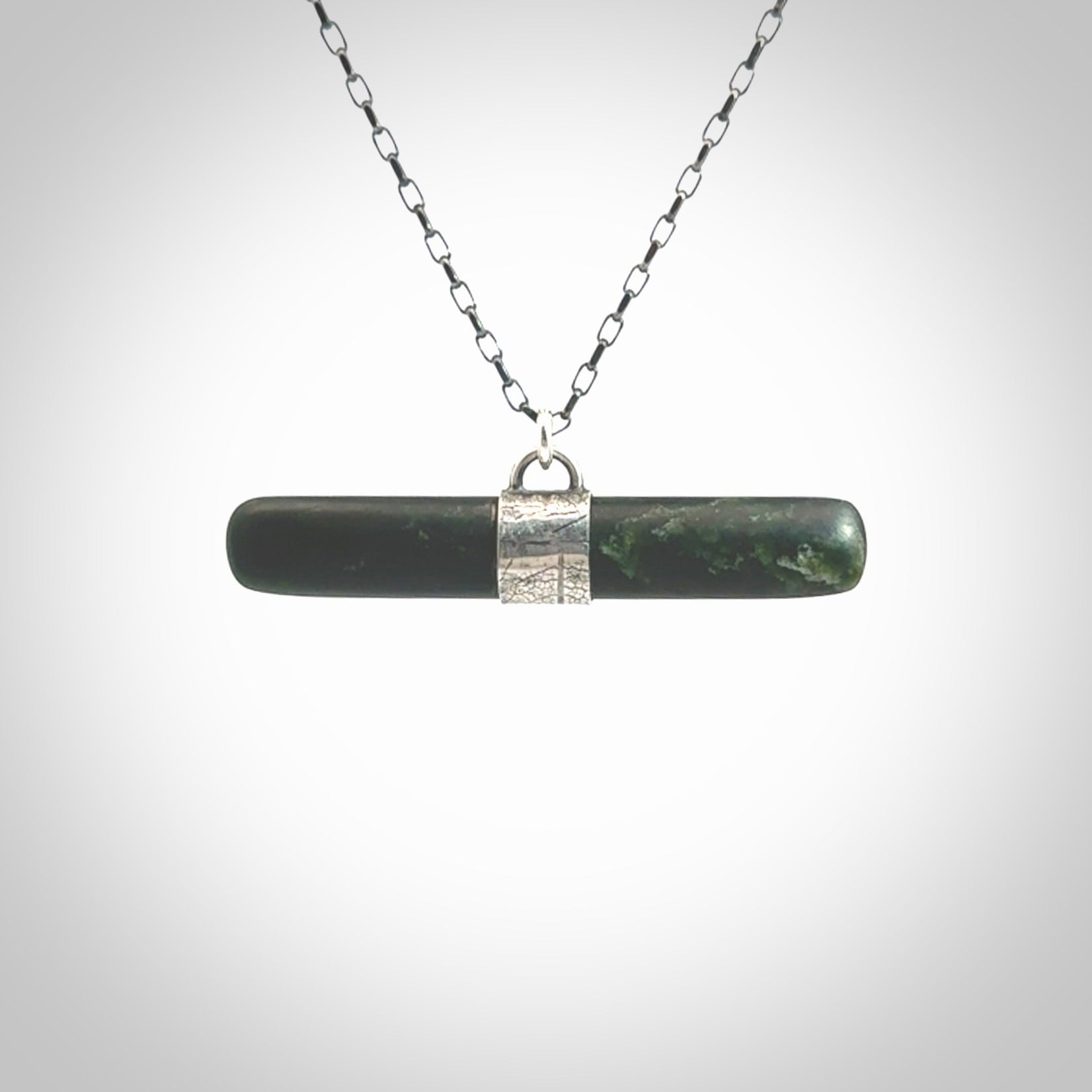 This is a beautiful green fob style drop design pendant that we has been carved here in New Zealand by Josey Coyle. It is carved from a piece of New Zealand Marsden Jade pounamu with Sterling Silver fittings and a sterling silver chain. A contemporary drop shaped pendant made to wear.