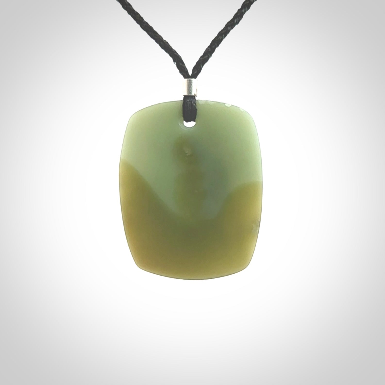 This is a Inanga Jade contemporary Drop pendant carved here in New Zealand by Josey Coyle. It is carved from a piece of rare New Zealand Inanga Pounamu, Jade. The jade is a subtle blue/green colour. A very finely carved pendant with an adjustable black cord.