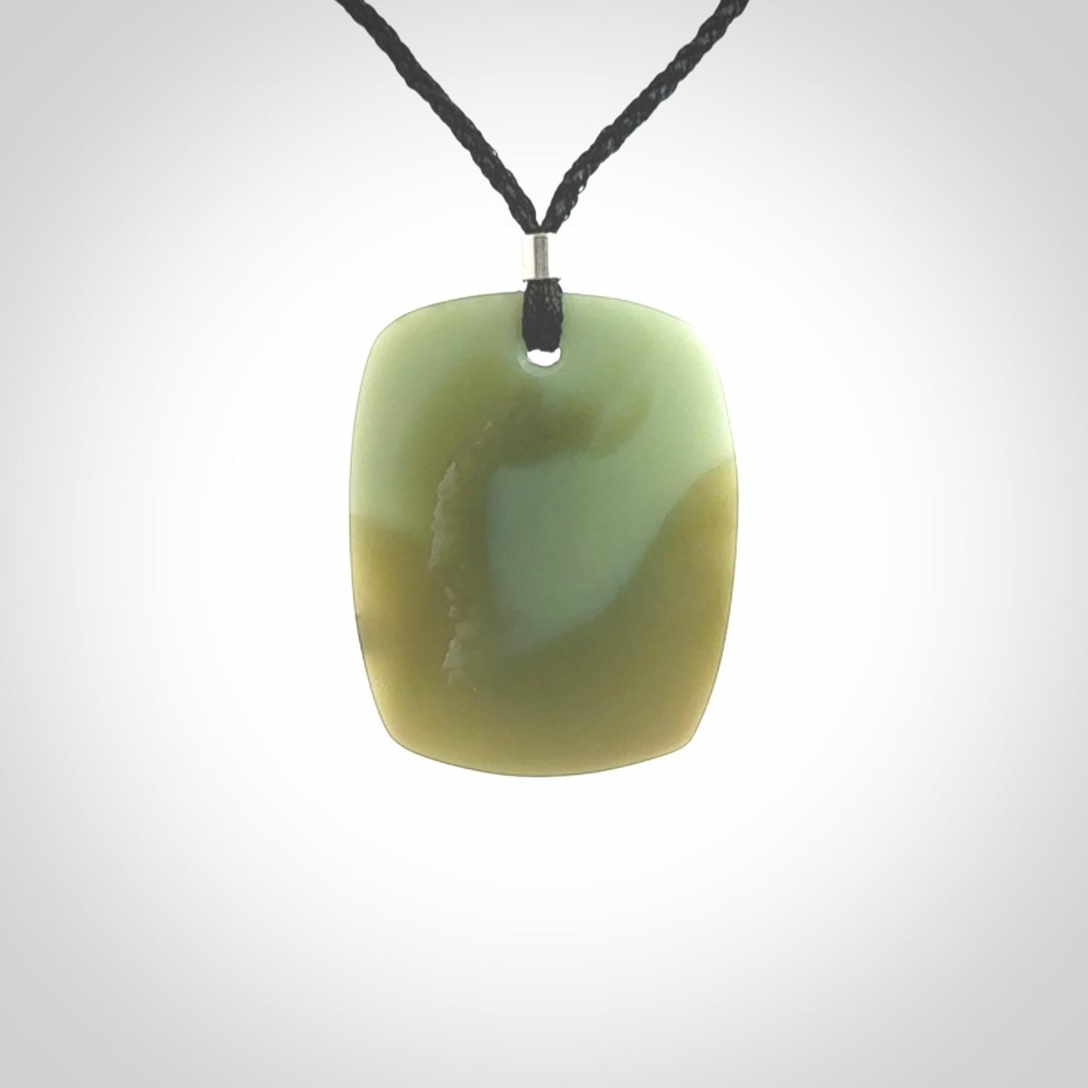 This is a Inanga Jade contemporary Drop pendant carved here in New Zealand by Josey Coyle. It is carved from a piece of rare New Zealand Inanga Pounamu, Jade. The jade is a subtle blue/green colour. A very finely carved pendant with an adjustable black cord.