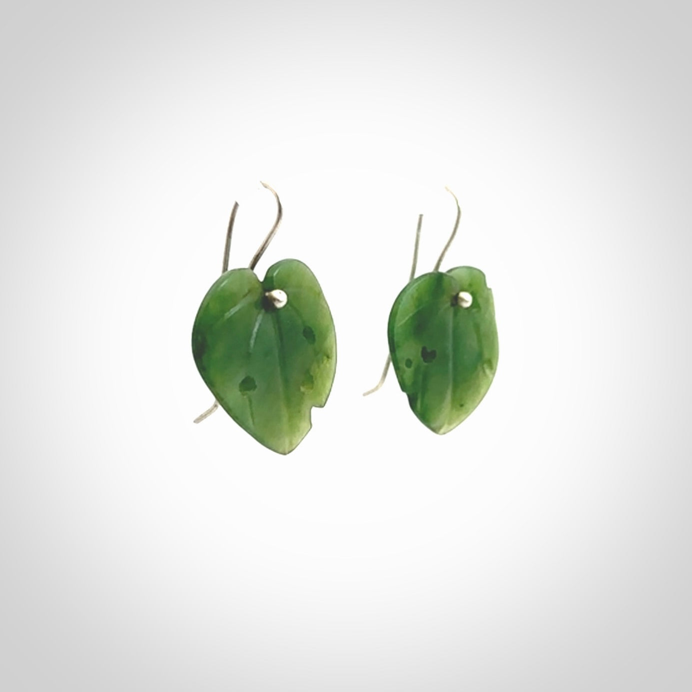 These are stunning heart shaped jade kawakawa leaf earrings carved in New Zealand by Josey Coyle. It is carved from a deep green piece of New Zealand Jade and with Sterling Silver hooks.