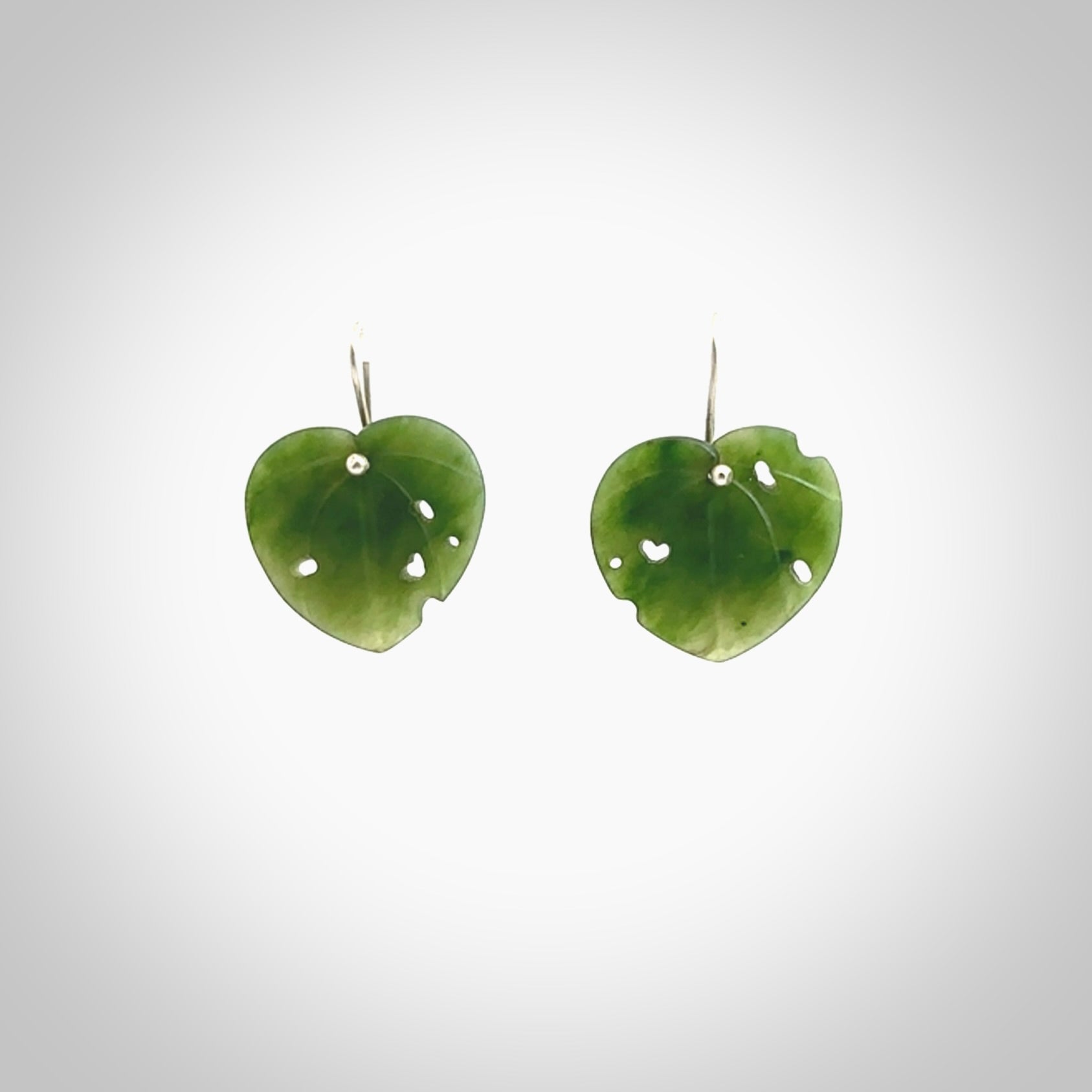 These are stunning heart shaped jade kawakawa leaf earrings carved in New Zealand by Josey Coyle. It is carved from a deep green piece of New Zealand Jade and with Sterling Silver hooks.