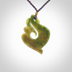 This photo shows a beautiful jade swan hook suspended from a hand plaited purple/brown cord. This swan hook was carved for us by Jen Hung who is a master jade carver from New Zealand.