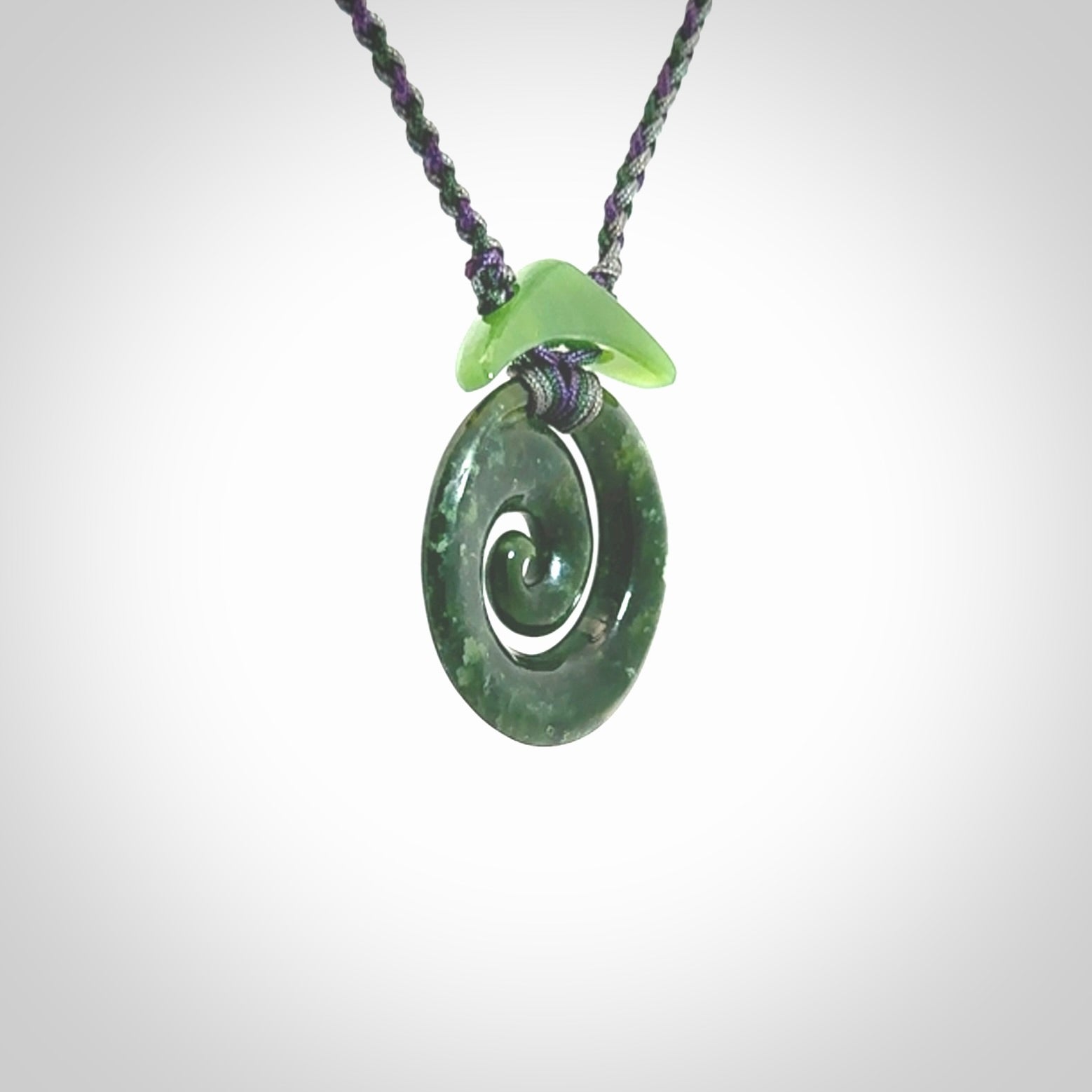 Hand carved New Zealand Jade Koru pendant with adjustable cord. This piece is a stand out work of creativity and skill and we love Jen Hung's creations. Unique, one only, New Zealand made necklace for sale. Free shipping worldwide.