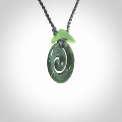 Hand carved New Zealand Jade Koru pendant with adjustable cord. This piece is a stand out work of creativity and skill and we love Jen Hung's creations. Unique, one only, New Zealand made necklace for sale. Free shipping worldwide.