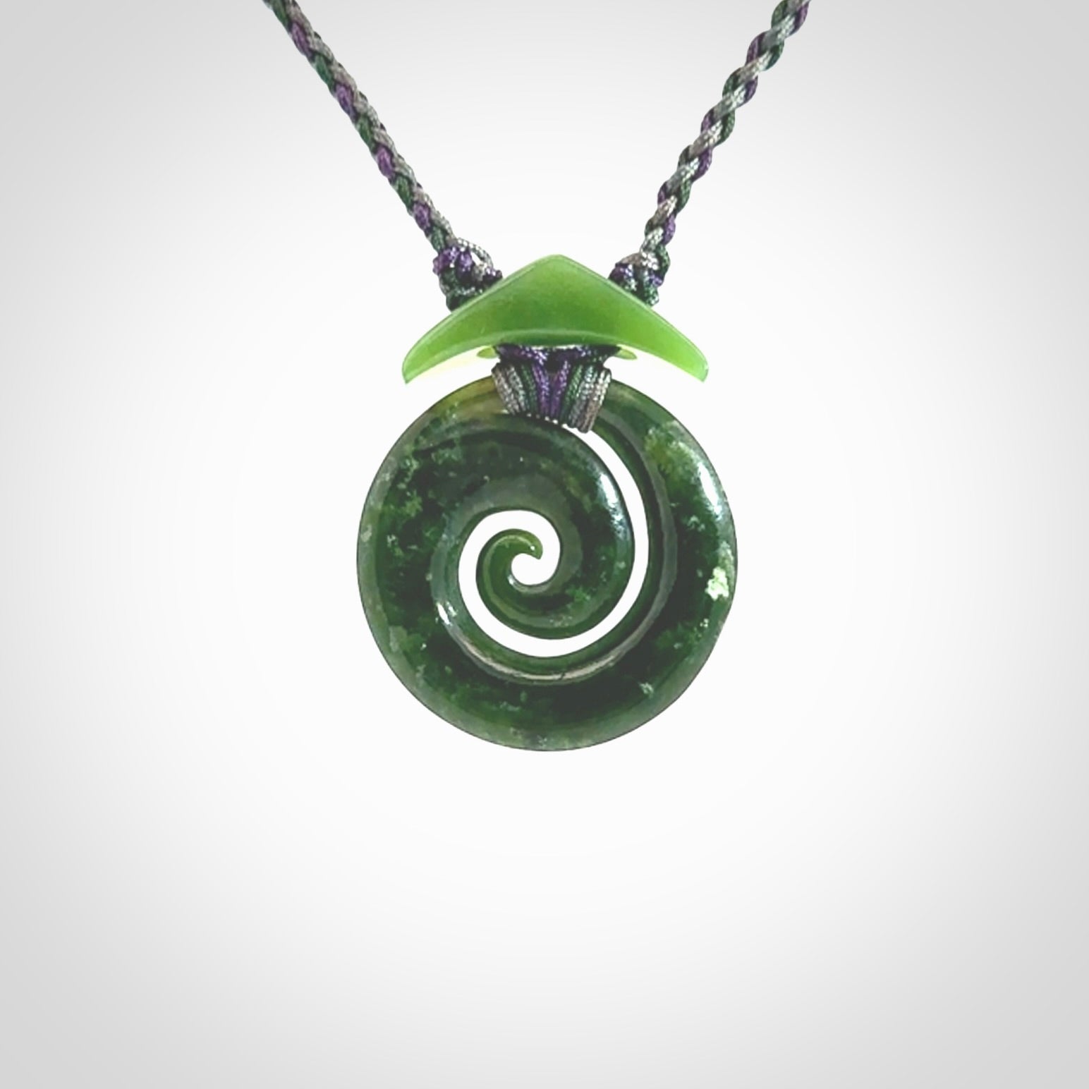 Hand carved New Zealand Jade Koru pendant with adjustable cord. This piece is a stand out work of creativity and skill and we love Jen Hung's creations. Unique, one only, New Zealand made necklace for sale. Free shipping worldwide.