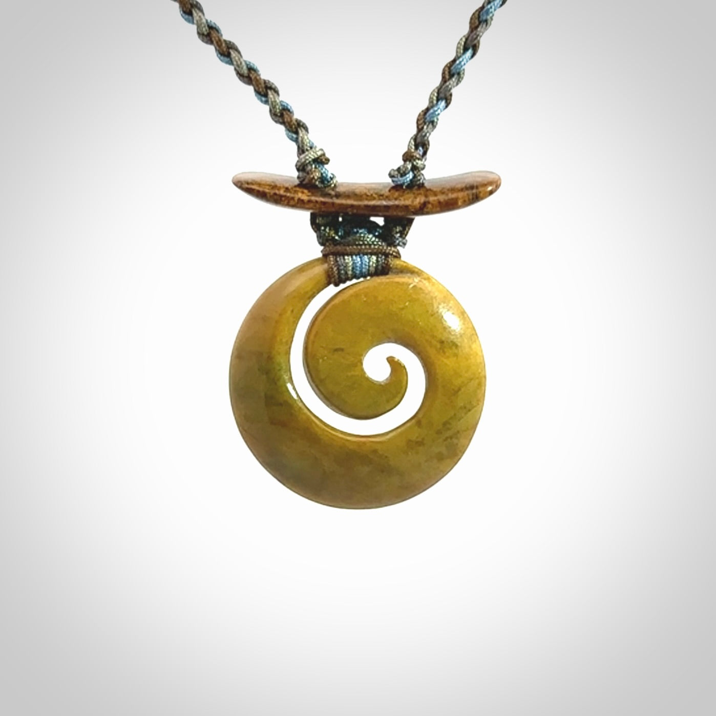 Hand carved New Zealand Flower Jade Koru pendant with adjustable cord. This piece is a stand out work of creativity and skill and we love Jen Hung's creations. Unique, one only, New Zealand made necklace for sale. Free shipping worldwide.