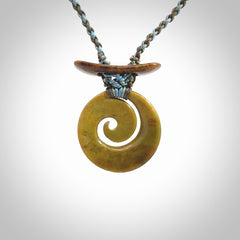 Hand carved New Zealand Flower Jade Koru pendant with adjustable cord. This piece is a stand out work of creativity and skill and we love Jen Hung's creations. Unique, one only, New Zealand made necklace for sale. Free shipping worldwide.