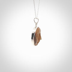 Hand made woolly mammoth tusk moon face necklace. Made by NZ Pacific and sale online only.