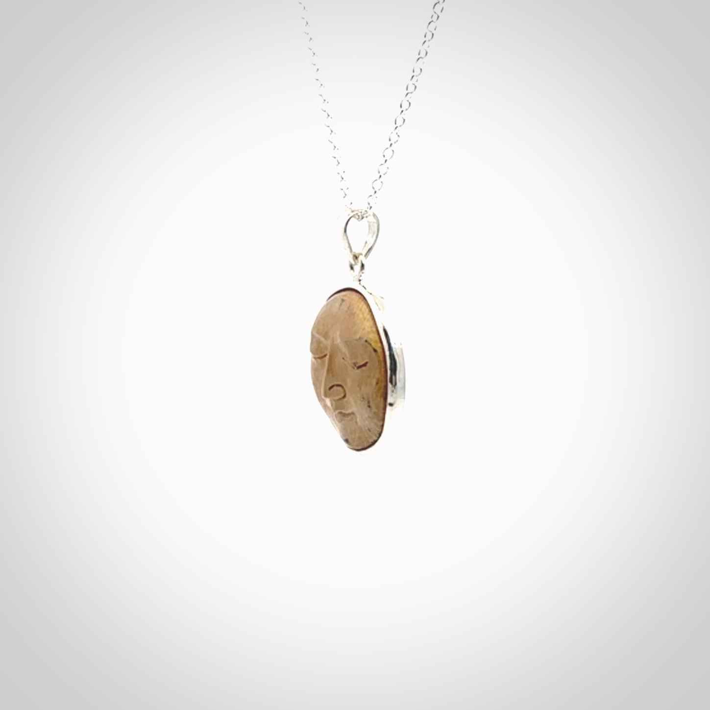 Hand made woolly mammoth tusk moon face necklace. Made by NZ Pacific and sale online only.