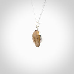 Hand made woolly mammoth tusk moon face necklace. Made by NZ Pacific and sale online only.