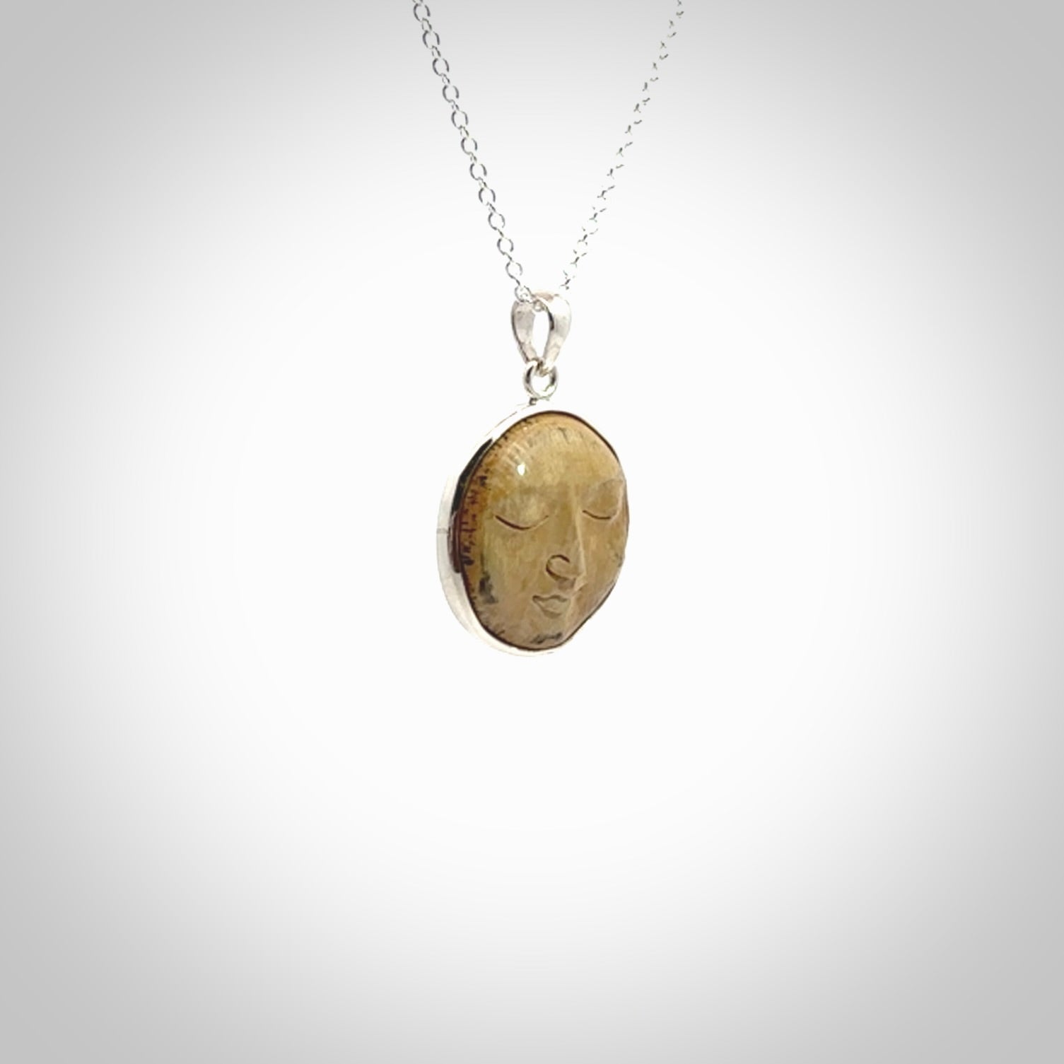 Hand made woolly mammoth tusk moon face necklace. Made by NZ Pacific and sale online only.