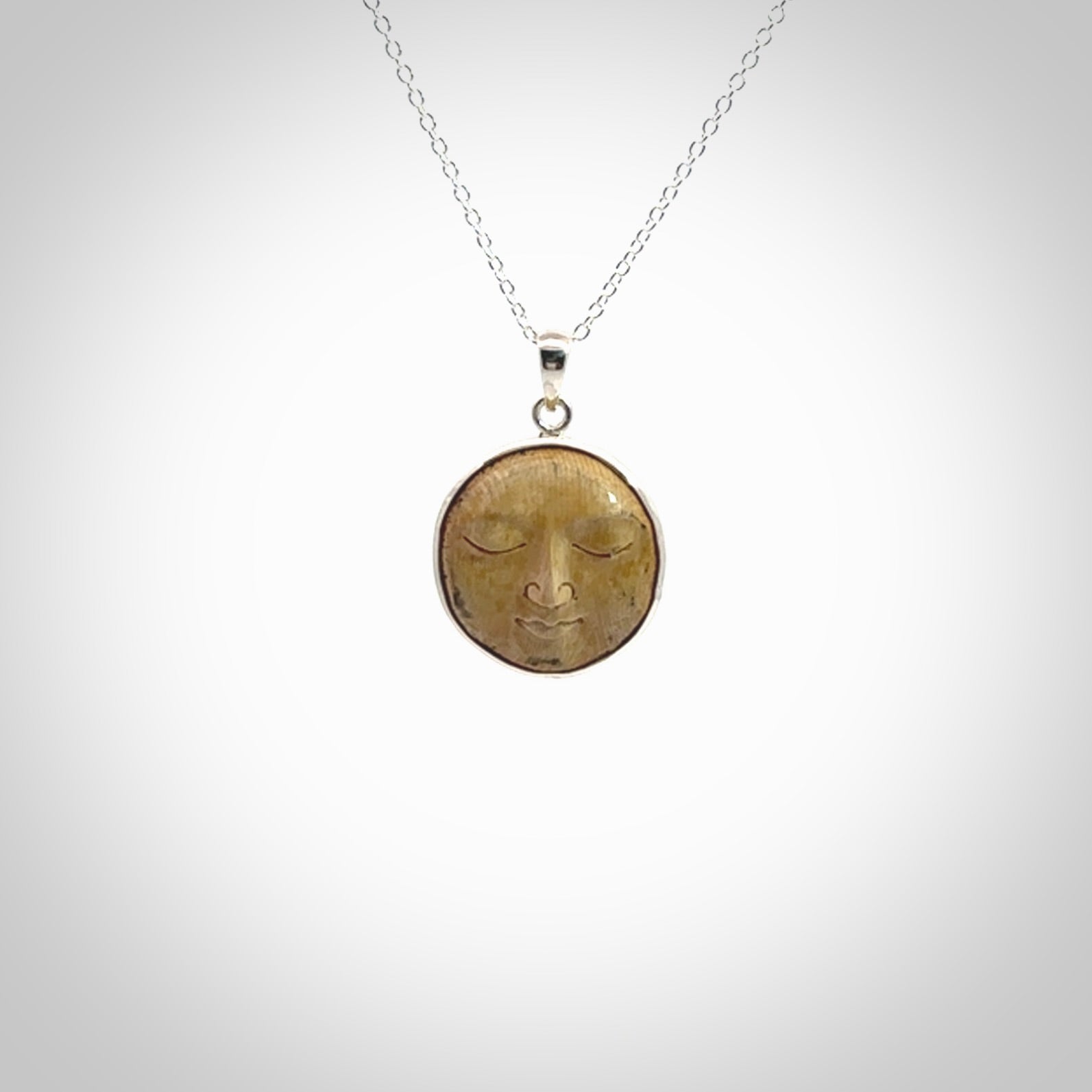 Hand made woolly mammoth tusk moon face necklace. Made by NZ Pacific and sale online only.