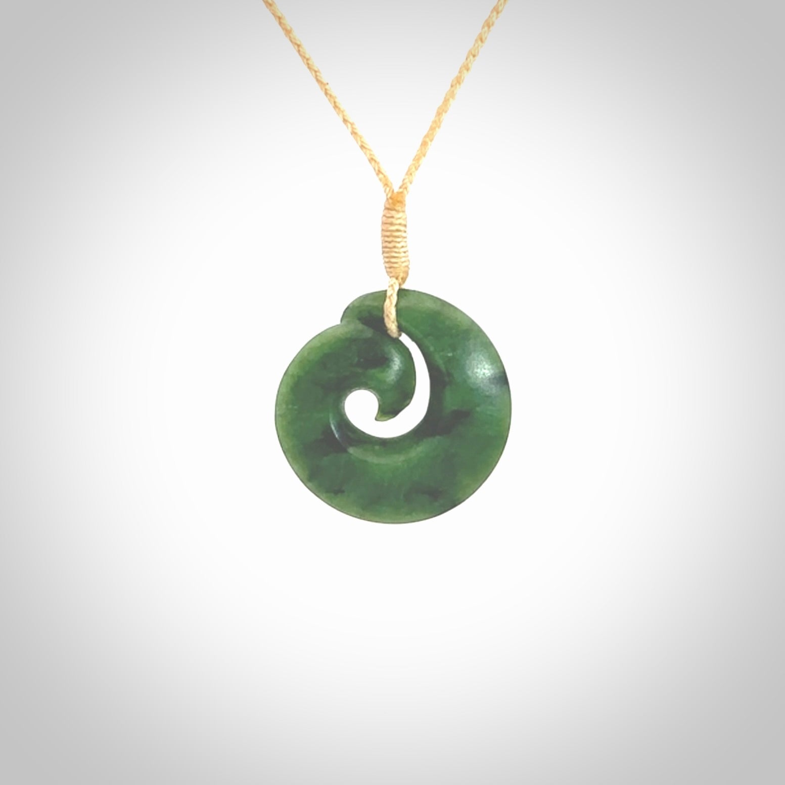 This picture shows a koru pendant, hand carved from New Zealand jade. We will provide this with an adjustable plaited cord. This has been hand carved by Kyohei Noguchi. One only pendant, shipped to you with express courier.