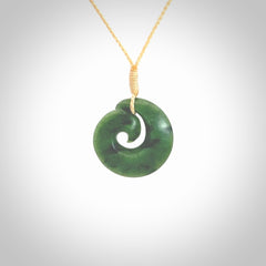 This picture shows a koru pendant, hand carved from New Zealand jade. We will provide this with an adjustable plaited cord. This has been hand carved by Kyohei Noguchi. One only pendant, shipped to you with express courier.