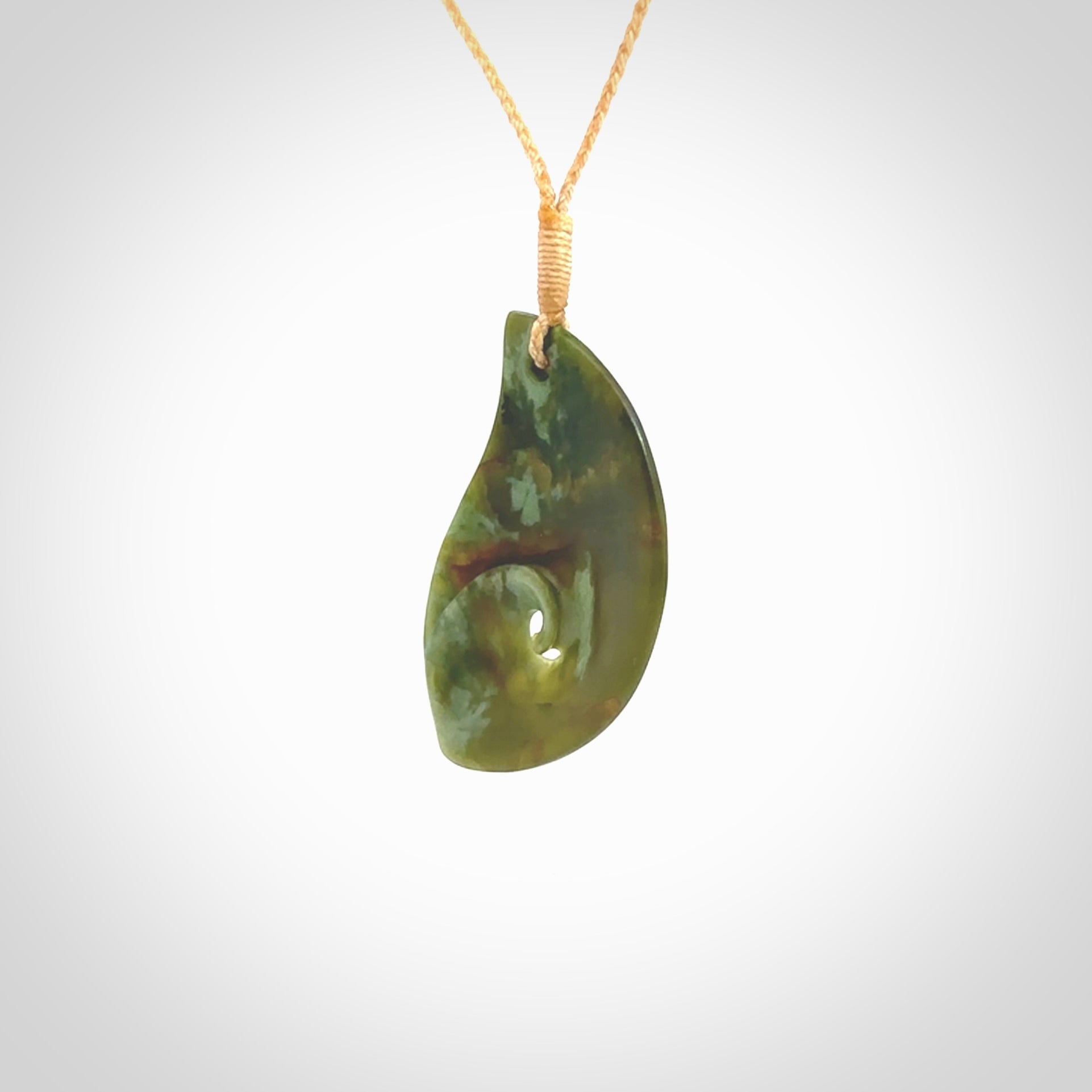 This pendant is a medium sized leaf drop design with koru heart necklace carved from a gorgeous piece of New Zealand Jade. Kyohei Noguchi carved this piece for us so the workmanship is outstanding. Handmade in New Zealand, a beautiful piece of jade jewellery.