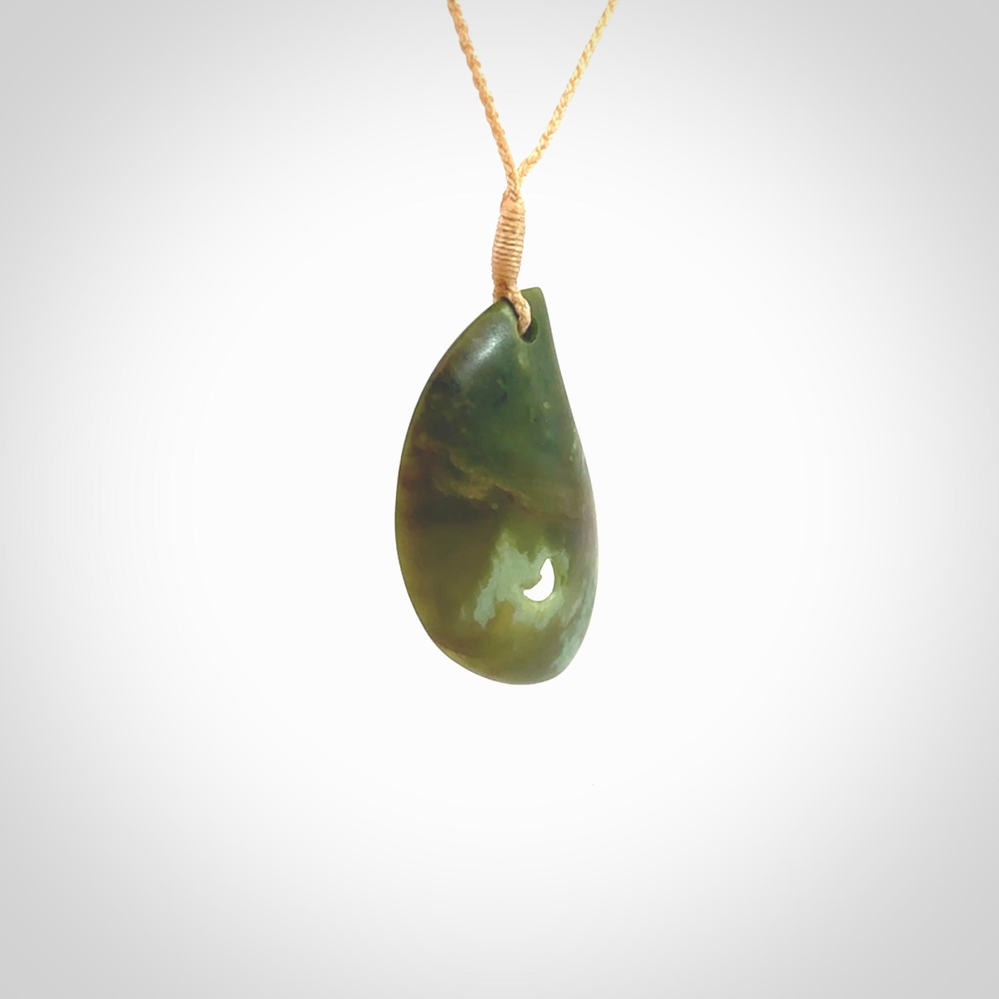 This pendant is a medium sized leaf drop design with koru heart necklace carved from a gorgeous piece of New Zealand Jade. Kyohei Noguchi carved this piece for us so the workmanship is outstanding. Handmade in New Zealand, a beautiful piece of jade jewellery.