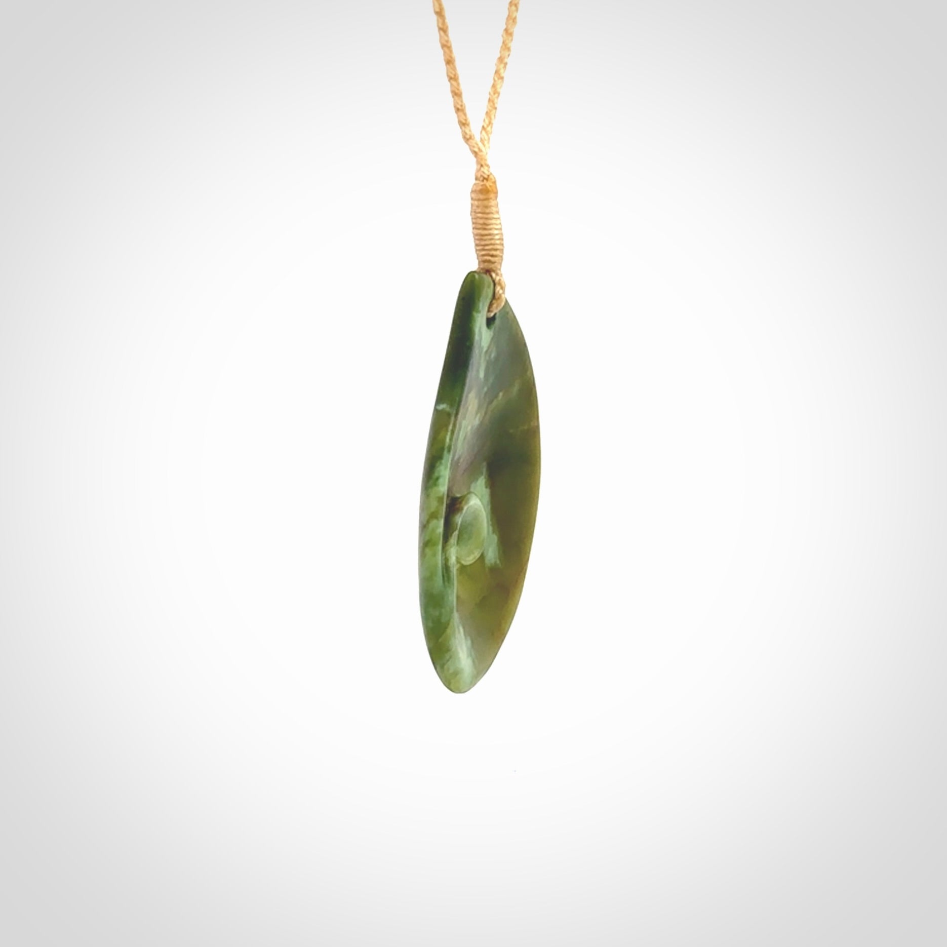 This pendant is a medium sized leaf drop design with koru heart necklace carved from a gorgeous piece of New Zealand Jade. Kyohei Noguchi carved this piece for us so the workmanship is outstanding. Handmade in New Zealand, a beautiful piece of jade jewellery.