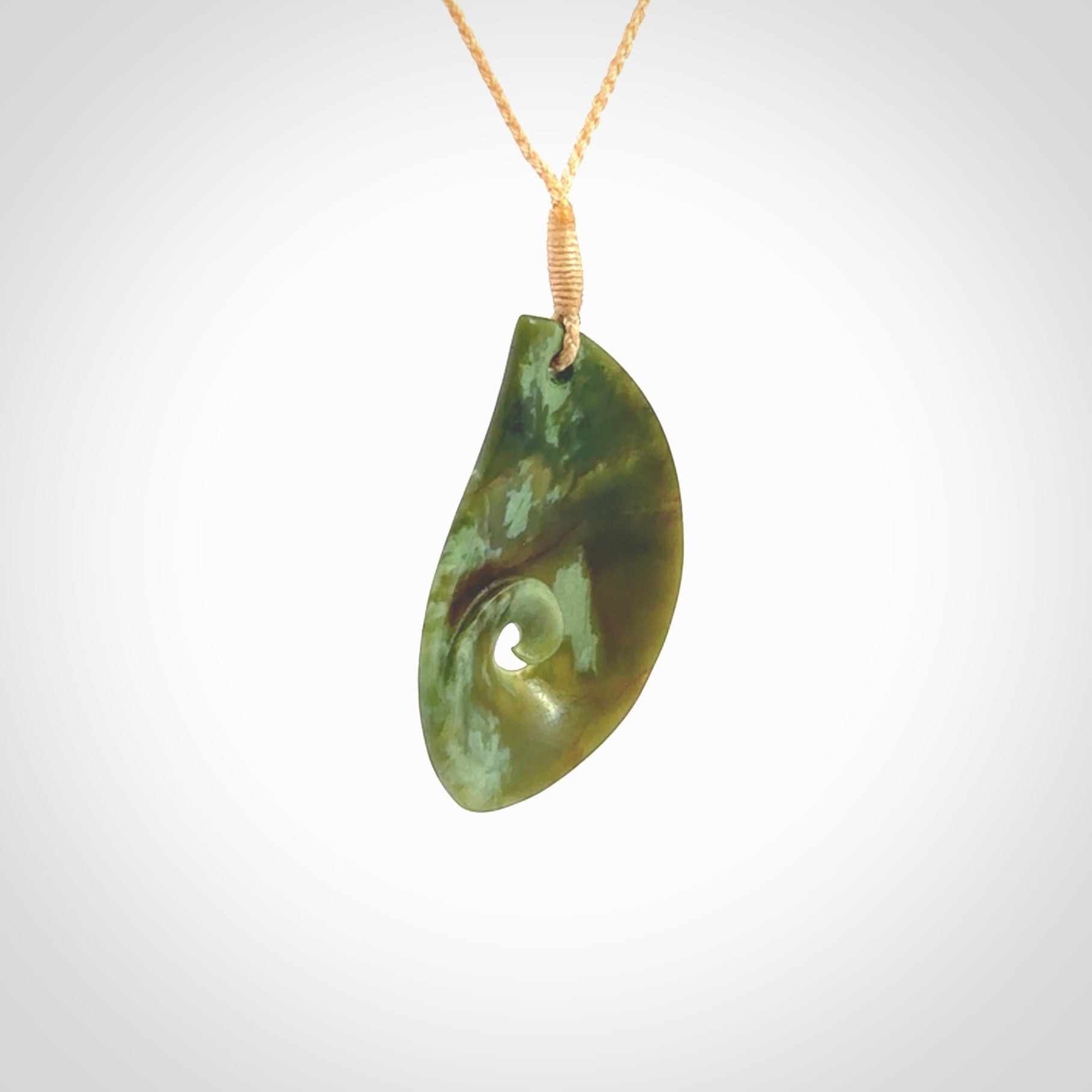 This pendant is a medium sized leaf drop design with koru heart necklace carved from a gorgeous piece of New Zealand Jade. Kyohei Noguchi carved this piece for us so the workmanship is outstanding. Handmade in New Zealand, a beautiful piece of jade jewellery.