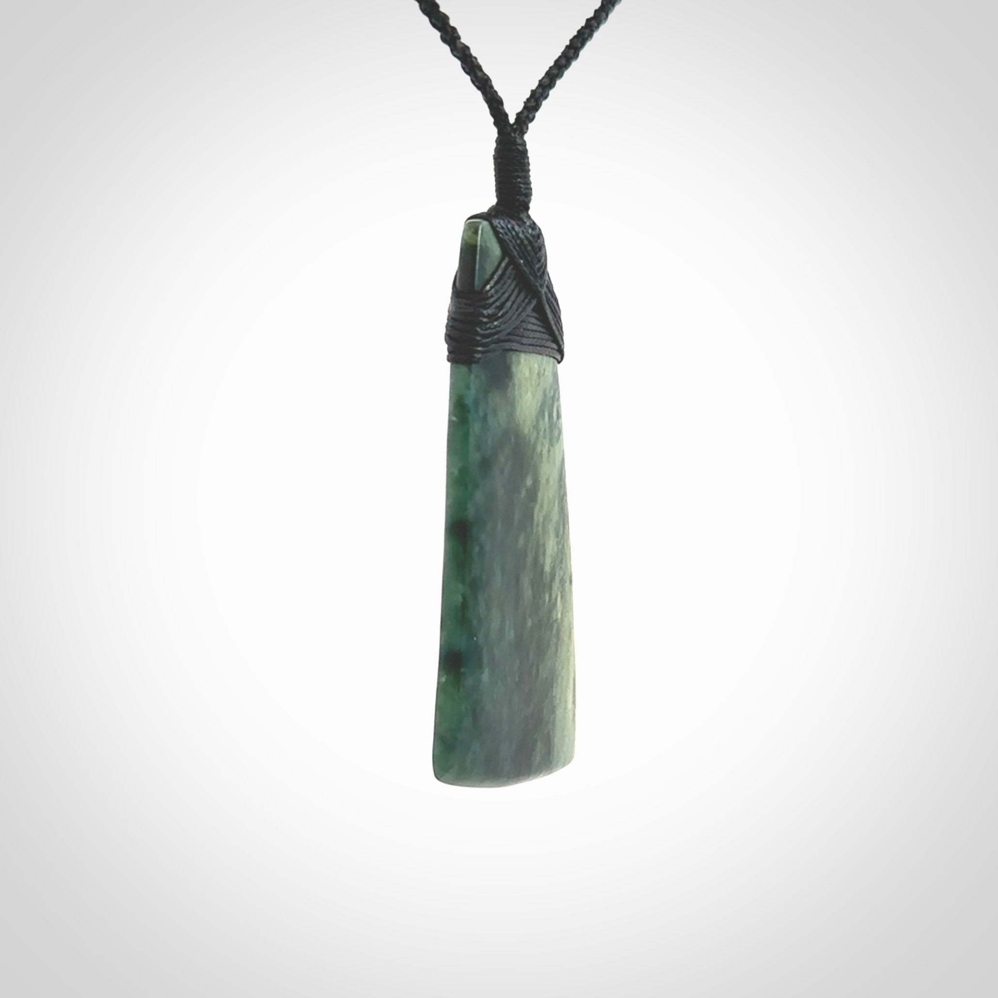 This Toki is hand carved from a lovely piece of local New Zealand Jade. The quality of the workmanship and design is outstanding - this is a piece you will want to wear all the time. We have suspended this from a 4-plait black cord which can be adjusted with a couple of slip knots and black binding. Hand made by Kyohei Noguchi.