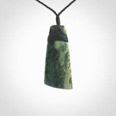 This Toki is hand carved from a lovely piece of local New Zealand Jade. The quality of the workmanship and design is outstanding - this is a piece you will want to wear all the time. We have suspended this from a 4-plait black cord which can be adjusted with a couple of slip knots and black binding. Hand made by Kyohei Noguchi.