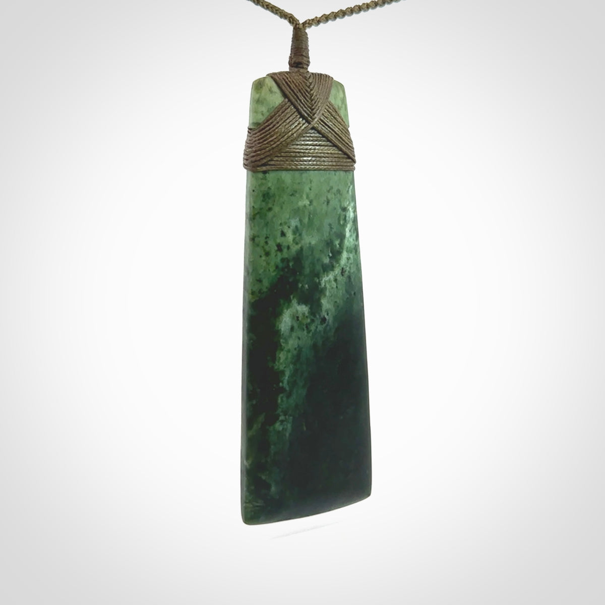 This large Toki is hand carved from a lovely piece of local New Zealand Jade. The quality of the workmanship and design is outstanding - this is a piece you will want to wear all the time. We have suspended this from a 4-plait olive green cord which can be adjusted with a couple of slip knots and olive binding. Hand made by Kyohei Noguchi.