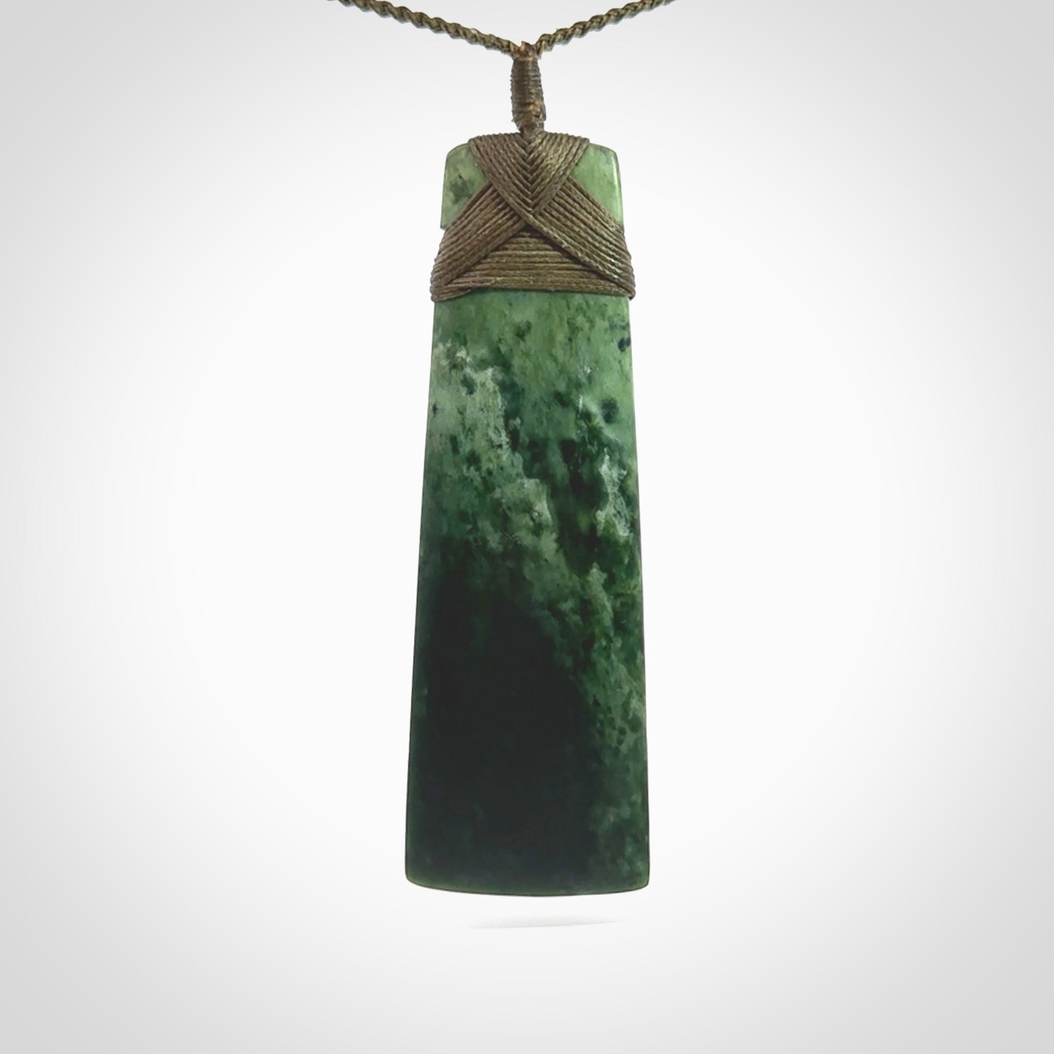 This large Toki is hand carved from a lovely piece of local New Zealand Jade. The quality of the workmanship and design is outstanding - this is a piece you will want to wear all the time. We have suspended this from a 4-plait olive green cord which can be adjusted with a couple of slip knots and olive binding. Hand made by Kyohei Noguchi.