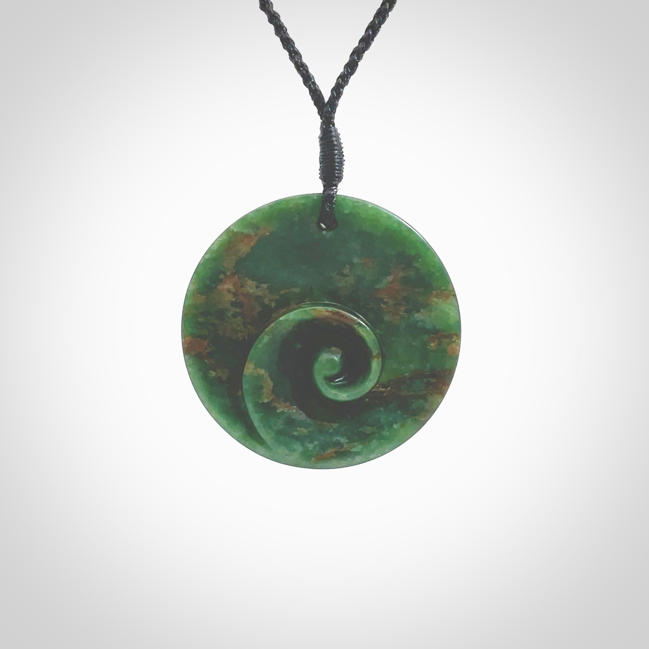 This pendant is a large sized and cupped koru necklace carved from a dark green piece of New Zealand Marsden Flower Jade. Kyohei Noguchi carved this piece for us so the workmanship is outstanding. Handmade in New Zealand, a beautiful piece of jade jewellery. Provided with an adjustable black cord and packaged in a woven kete pouch.