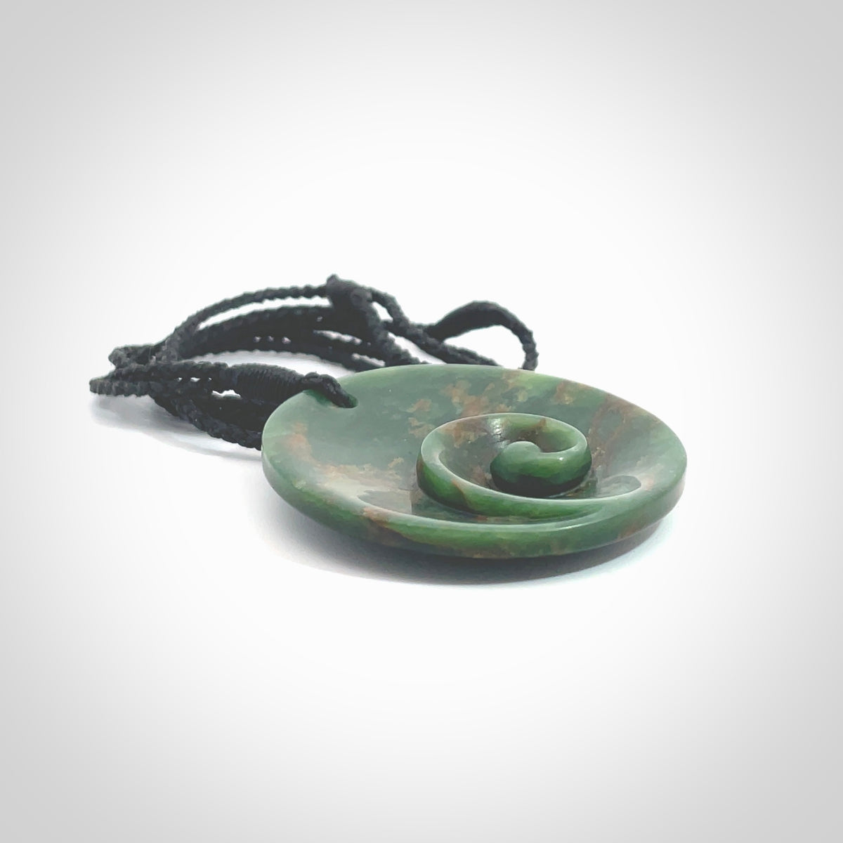 This pendant is a large sized and cupped koru necklace carved from a dark green piece of New Zealand Marsden Flower Jade. Kyohei Noguchi carved this piece for us so the workmanship is outstanding. Handmade in New Zealand, a beautiful piece of jade jewellery. Provided with an adjustable black cord and packaged in a woven kete pouch.