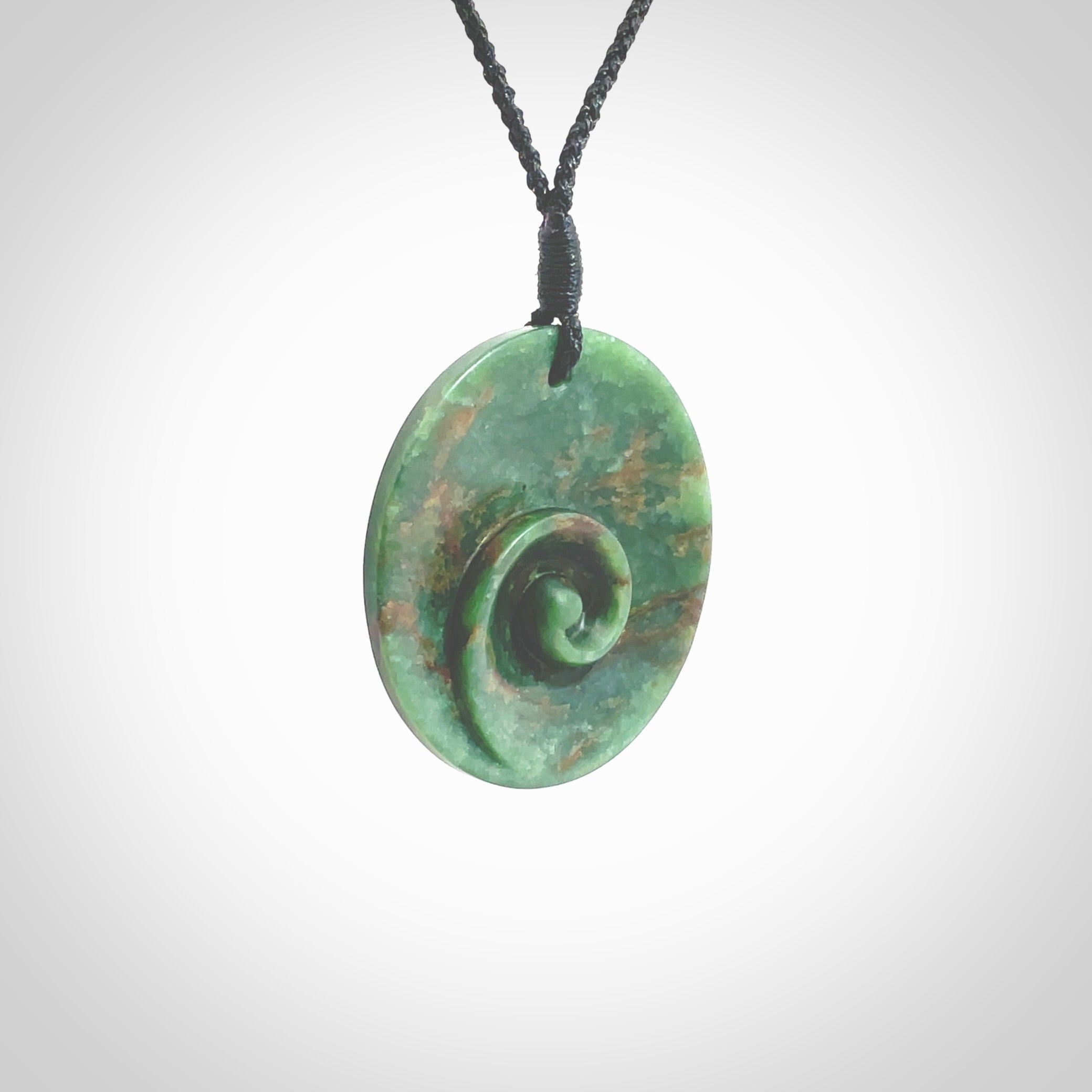 This pendant is a large sized and cupped koru necklace carved from a dark green piece of New Zealand Marsden Flower Jade. Kyohei Noguchi carved this piece for us so the workmanship is outstanding. Handmade in New Zealand, a beautiful piece of jade jewellery. Provided with an adjustable black cord and packaged in a woven kete pouch.