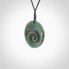 This pendant is a large sized and cupped koru necklace carved from a dark green piece of New Zealand Marsden Flower Jade. Kyohei Noguchi carved this piece for us so the workmanship is outstanding. Handmade in New Zealand, a beautiful piece of jade jewellery. Provided with an adjustable black cord and packaged in a woven kete pouch.