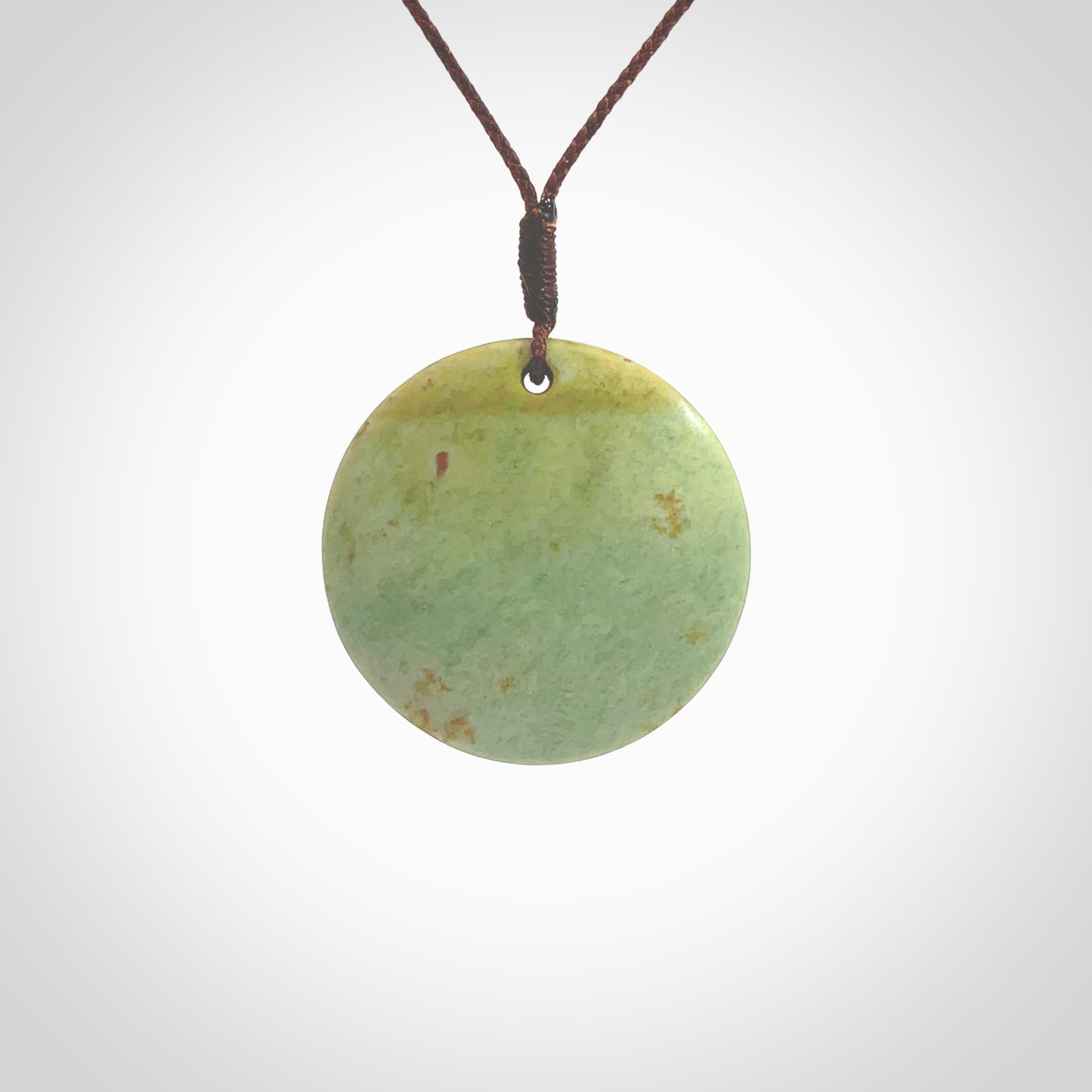 This pendant is a medium sized and cupped koru necklace carved from a lovely light green piece of New Zealand Marsden Flower Jade. Kyohei Noguchi carved this piece for us so the workmanship is outstanding. Handmade in New Zealand, a beautiful piece of jade jewellery. Provided with an adjustable brown cord and packaged in a woven kete pouch.