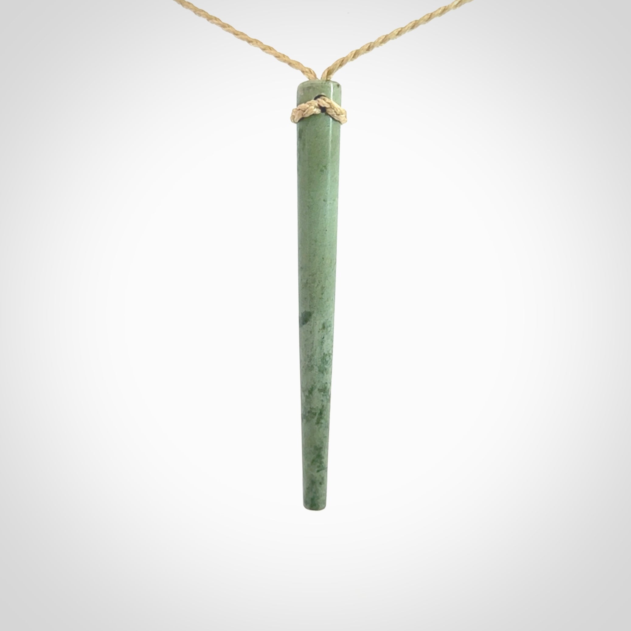 A hand carved New Zealand Jade Drop pendant. The cord and binding is oat coloured and is adjustable. Large hand made drop necklace by New Zealand artist Kristal Thompson. One off work of art to wear.