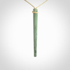 A hand carved New Zealand Jade Drop pendant. The cord and binding is oat coloured and is adjustable. Large hand made drop necklace by New Zealand artist Kristal Thompson. One off work of art to wear.