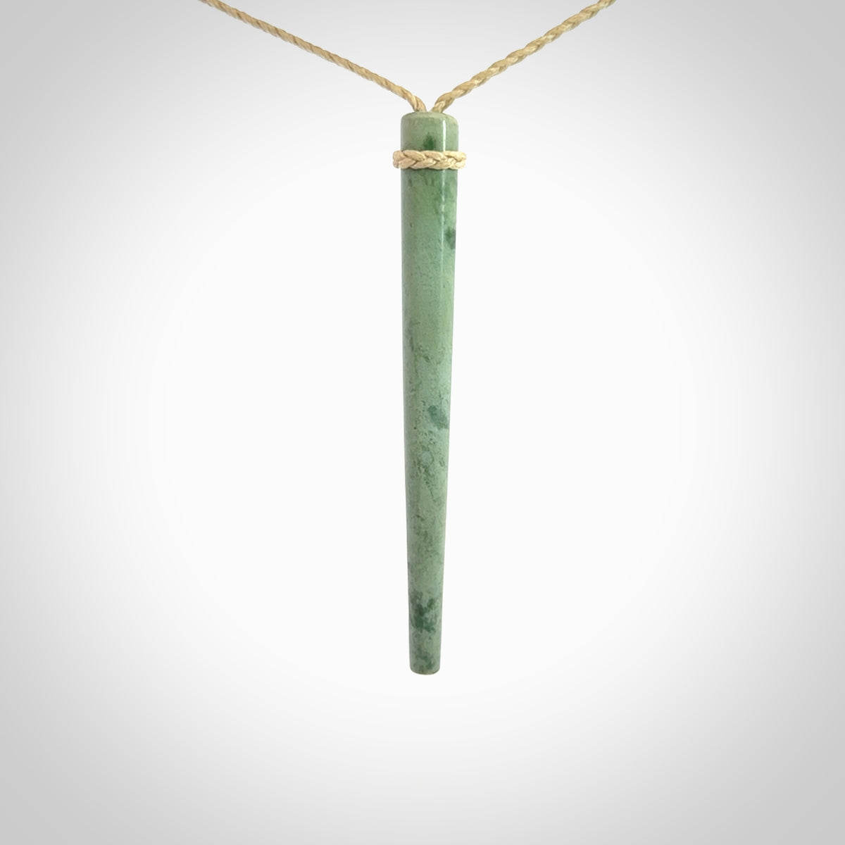 A hand carved New Zealand Jade Drop pendant. The cord and binding is oat coloured and is adjustable. Large hand made drop necklace by New Zealand artist Kristal Thompson. One off work of art to wear.