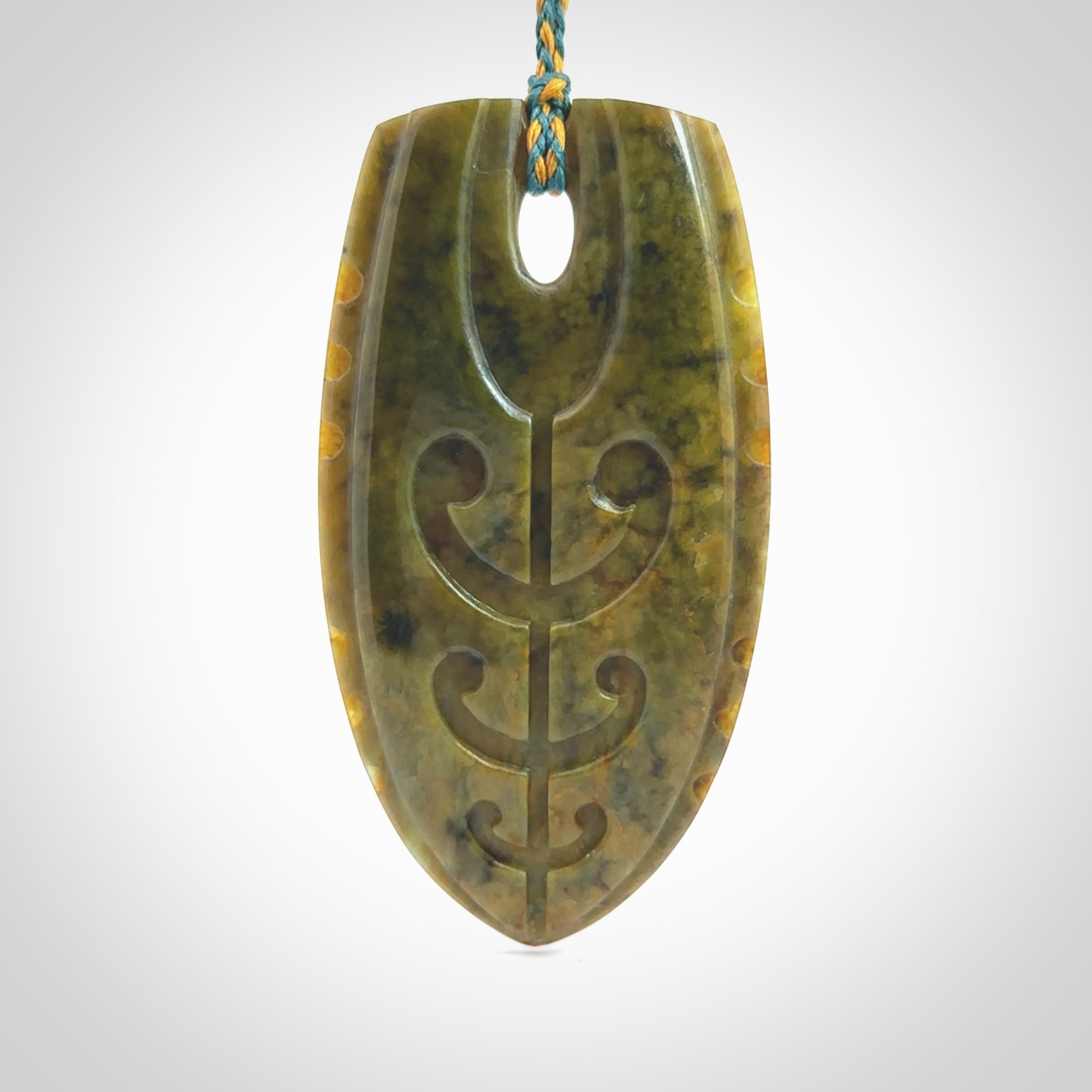 This photo shows a large Niho with koru carved into New Zealand Flower Jade. The artist, Kerry Thompson, has carved this beautifully. We have added a Sea Moss Blue/Harvest Gold adjustable cord. This is a fantastic work of art, we have one only.