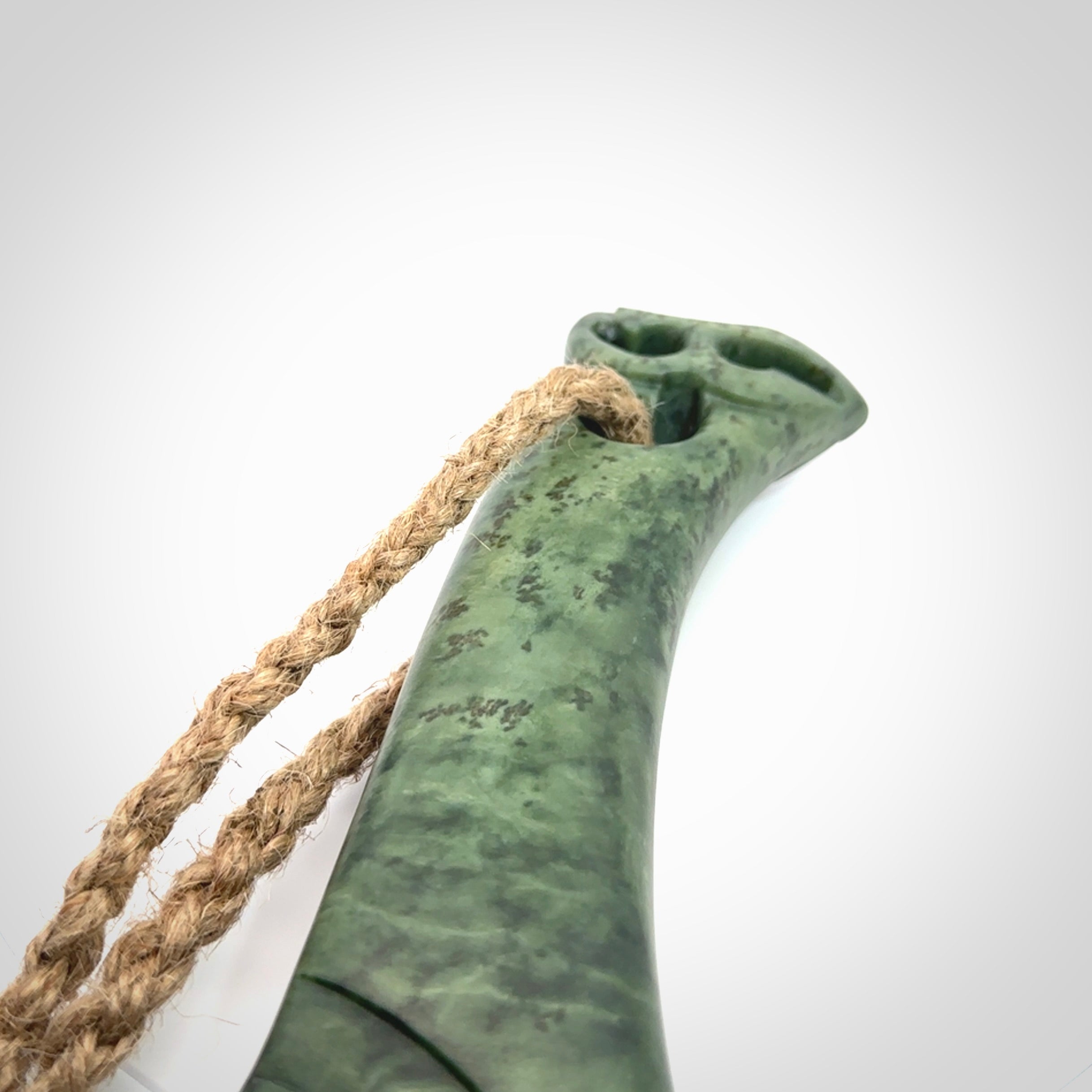 Hand carved wahaika Pounamu. Art to display. One only hand made wahaika display piece with base. New Zealand wahaika carved in Pounamu, Jade by Kerry Thompson. Free delivery worldwide.