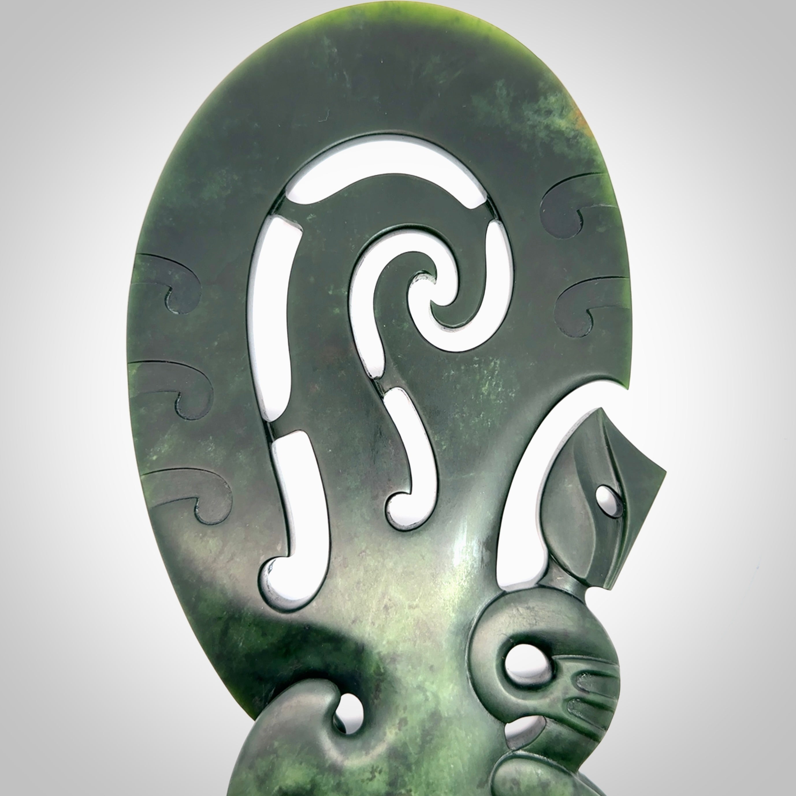 Hand carved wahaika Pounamu. Art to display. One only hand made wahaika display piece with base. New Zealand wahaika carved in Pounamu, Jade by Kerry Thompson. Free delivery worldwide.