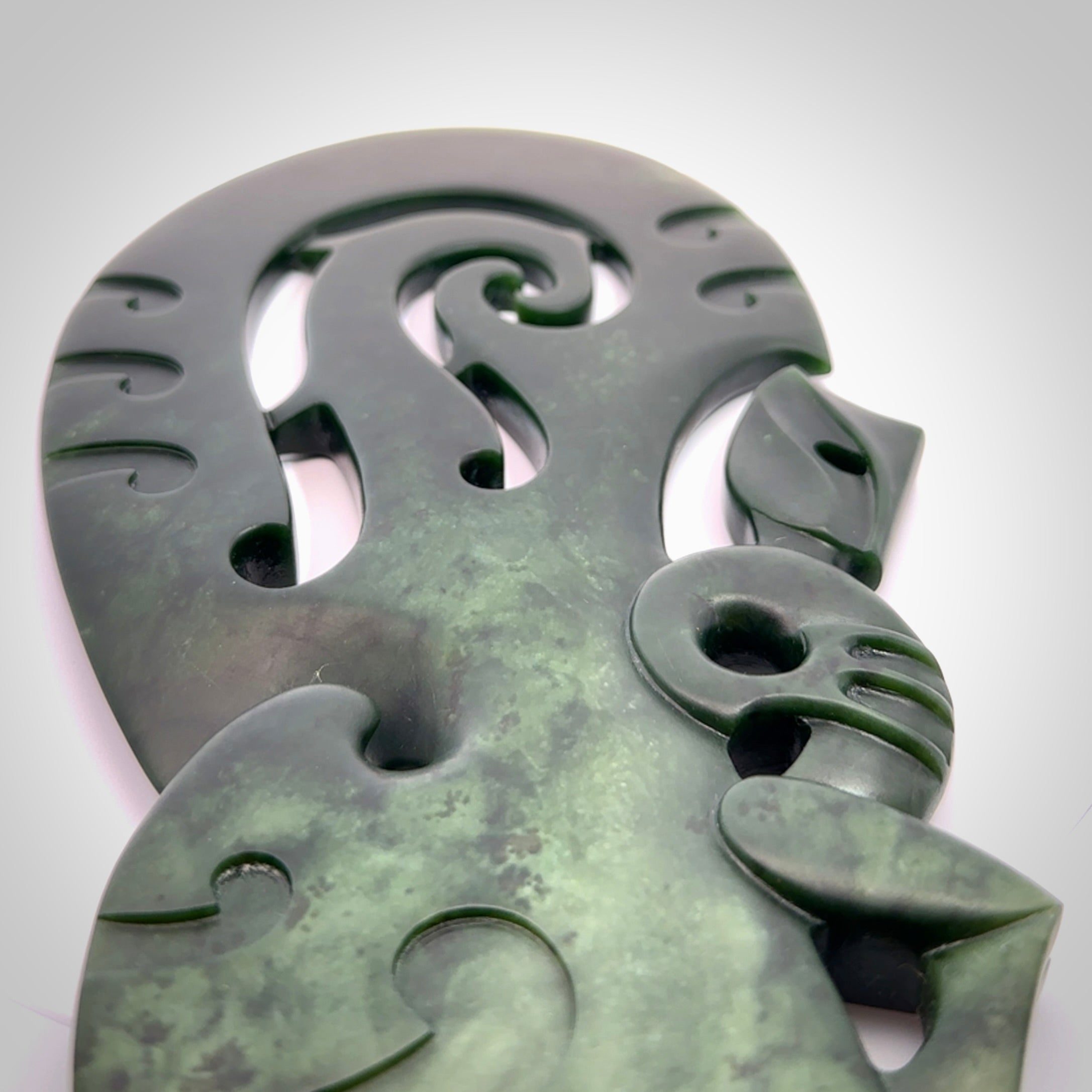 Hand carved wahaika Pounamu. Art to display. One only hand made wahaika display piece with base. New Zealand wahaika carved in Pounamu, Jade by Kerry Thompson. Free delivery worldwide.